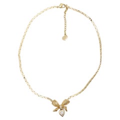 Christian Dior, collier pendentif vintage en forme de cœur en or avec nœud papillon et cristaux, années 1970