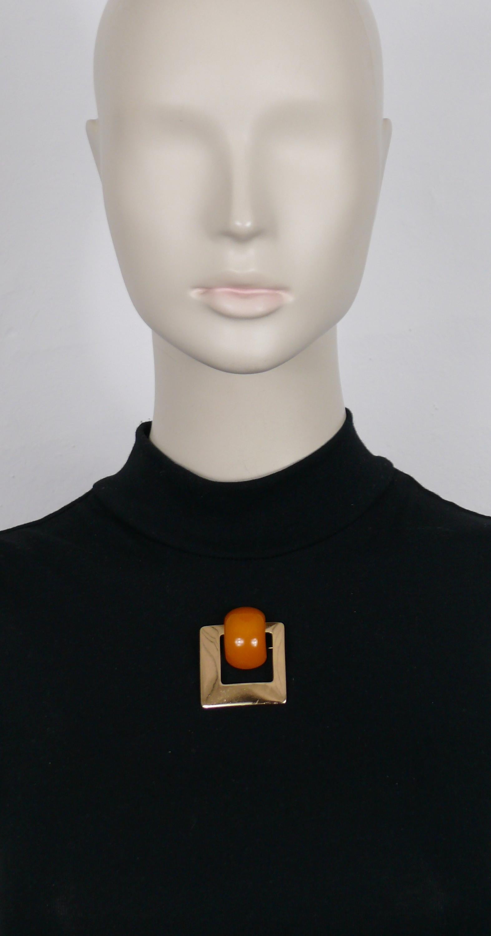 CHRISTIAN DIOR vintage gold tone modernist brooch embellished with an amber color resin cabochon.

Embossed 19 CHR. DIOR © 71 Germany.

Indicative measurements : max. height approx. 4.7 cm (1.85 inches) / max. width approx. 4 cm (1.57