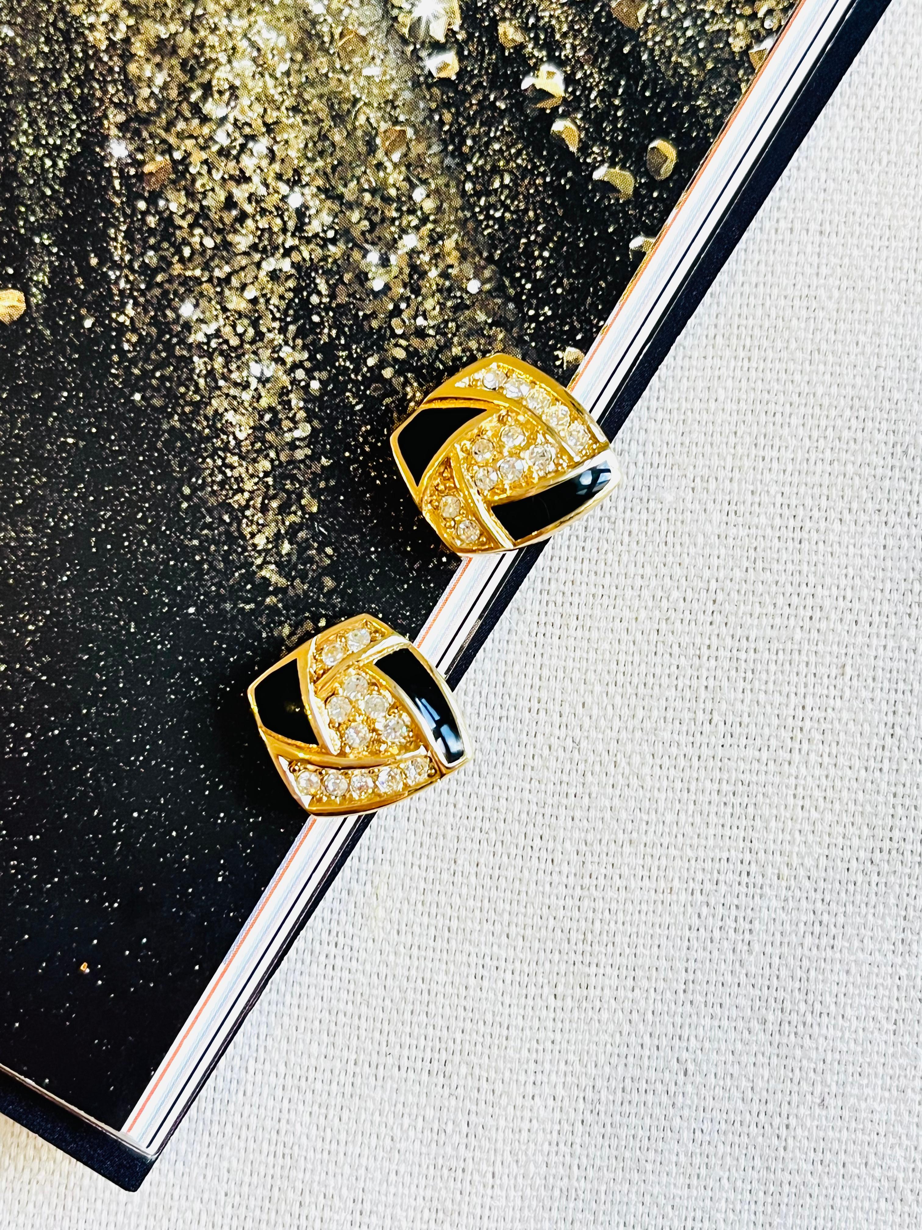 Renowned for its timeless elegant designs, Christian Dior presents this earrings. Crafted from polished gold plated brass, the piece is adorned with dazzling Swarovski crystal embellishments and finished with black enamel detailing. Signed at the