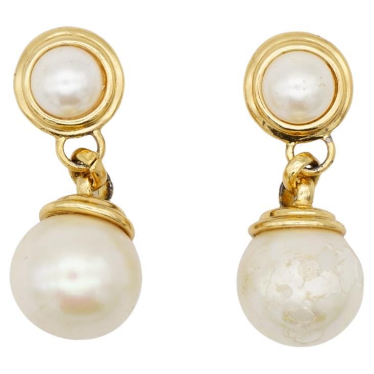 Christian Dior Vintage 1980s Double White Round Ball Pearls Drop Dangle Elegant Clip Earrings, Gold Tone

Good condition. One earring has been peeled off at pearl. Still very good to look when wearing them. 100% Genuine.

A very beautiful pair of