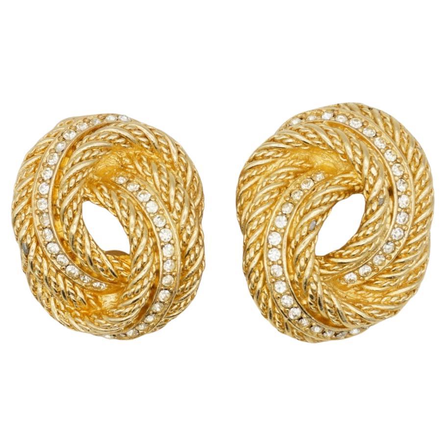 Christian Dior Vintage 1980er Jahre große Knoten Twist Wirbel Seil Kristalle Clip Ohrringe, Gold-Ton

Sehr guter Zustand. 100% echt. Sehr leichte Kratzer oder Farbverluste, kaum wahrnehmbar. 

Ein sehr schönes Paar Ohrringe von Chr. DIOR, signiert