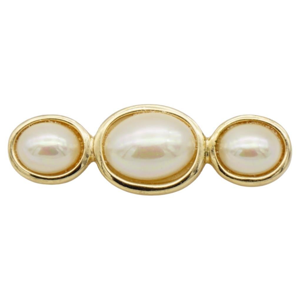Christian Dior Vintage 1980s Three Trio White Oval Pearls Long Bar Brooch, Gold Plated

Very good condition. 100% Genuine.

A unique piece. This gold plated stylised brooch with three gorgeous faux pearls. 

Safety-catch pin closure, signed