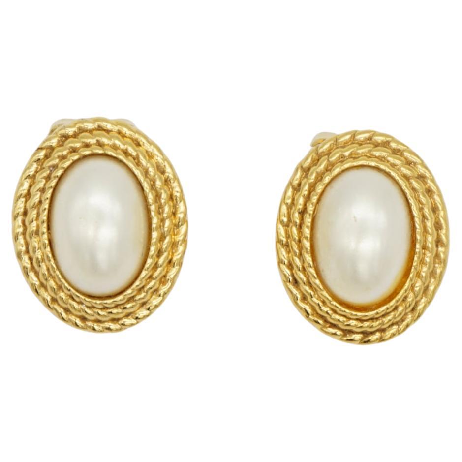 Christian Dior Vintage 1980s White Oval Pearl Triple Layer Swirl Braid Clip Earrings, Gold Plated

Very good condition. Very light small marks on the edge of faux pearls, barely noticeable. 100% Genuine.

A very beautiful pair of earrings by Chr.