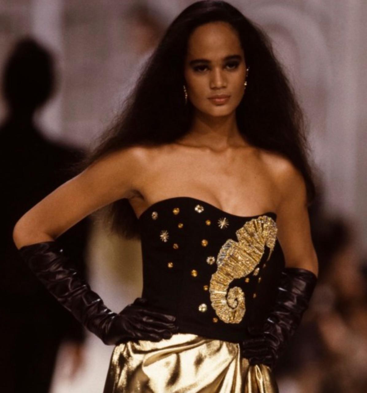 This stunning Christian Dior vintage bustier from Spring/Summer 1989 is a true collector's item. Crafted from midnight blue linen weave fabric, it is adorned with exquisitely beaded gold crystals in the shape of marine motifs, creating an