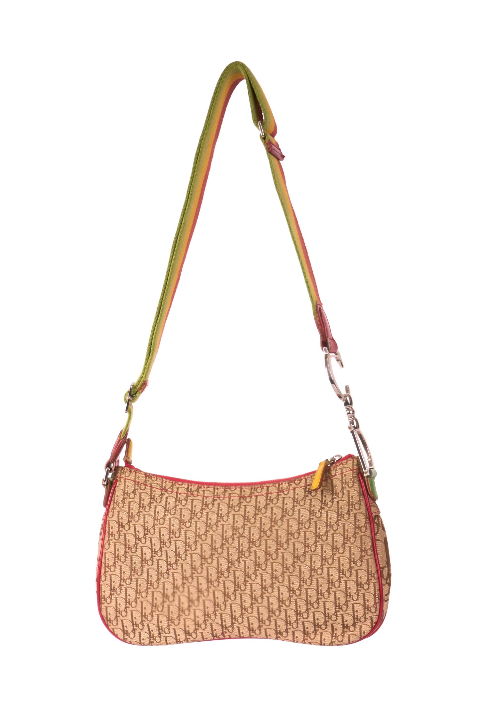 Christian Dior by John Galliano 2004  saddle messenger bag. Features ‘Dior’ and ‘CD’ signature on one side of the strap (adjustable strap) canvas and leather detailing all over, monogram print, small front pocket, zip closure and one interior