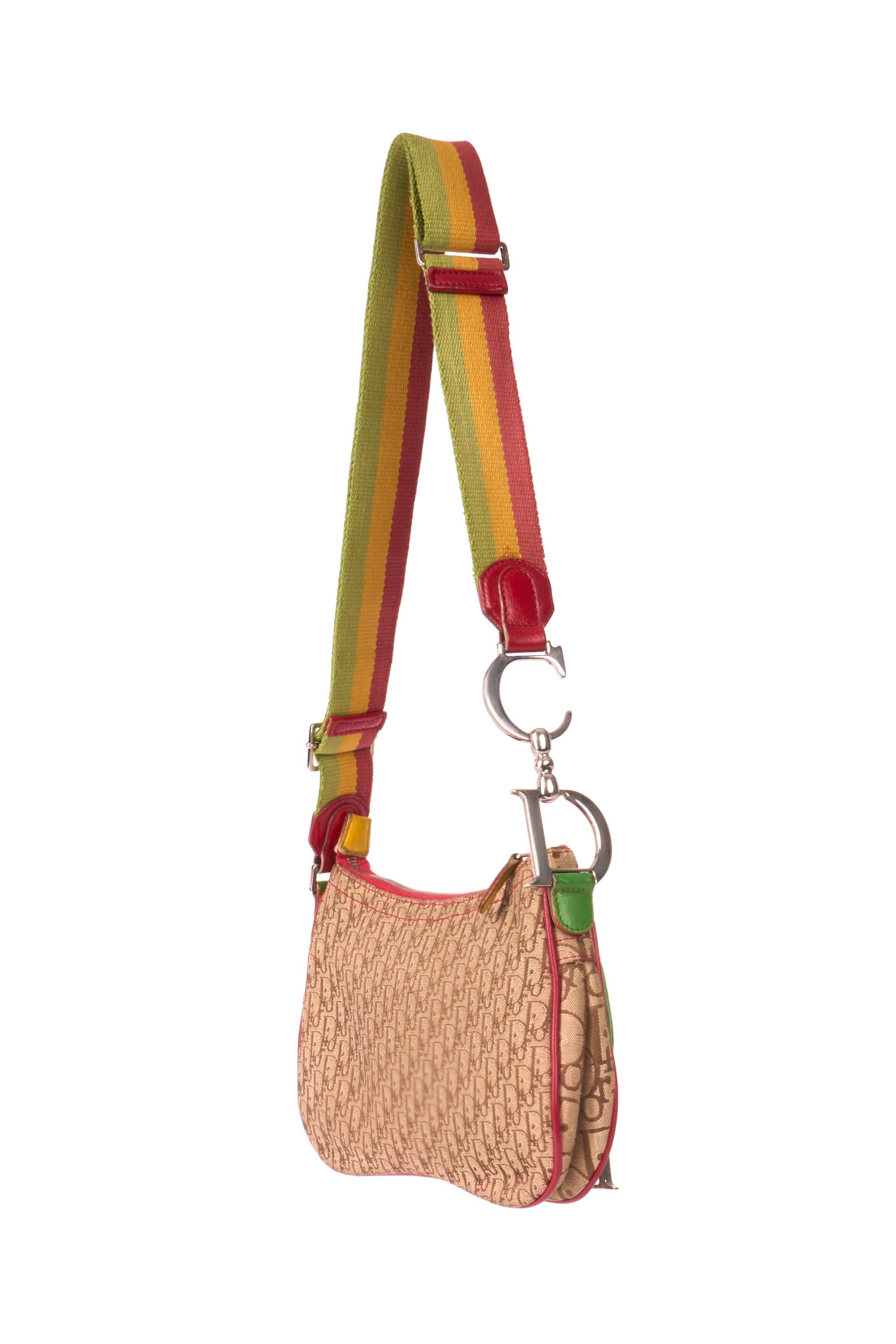 Christian Dior by John Galliano 2004  saddle messenger bag. Features ‘Dior’ and ‘CD’ signature on one side of the strap (adjustable strap) canvas and leather detailing all over, monogram print, small front pocket, zip closure and one interior