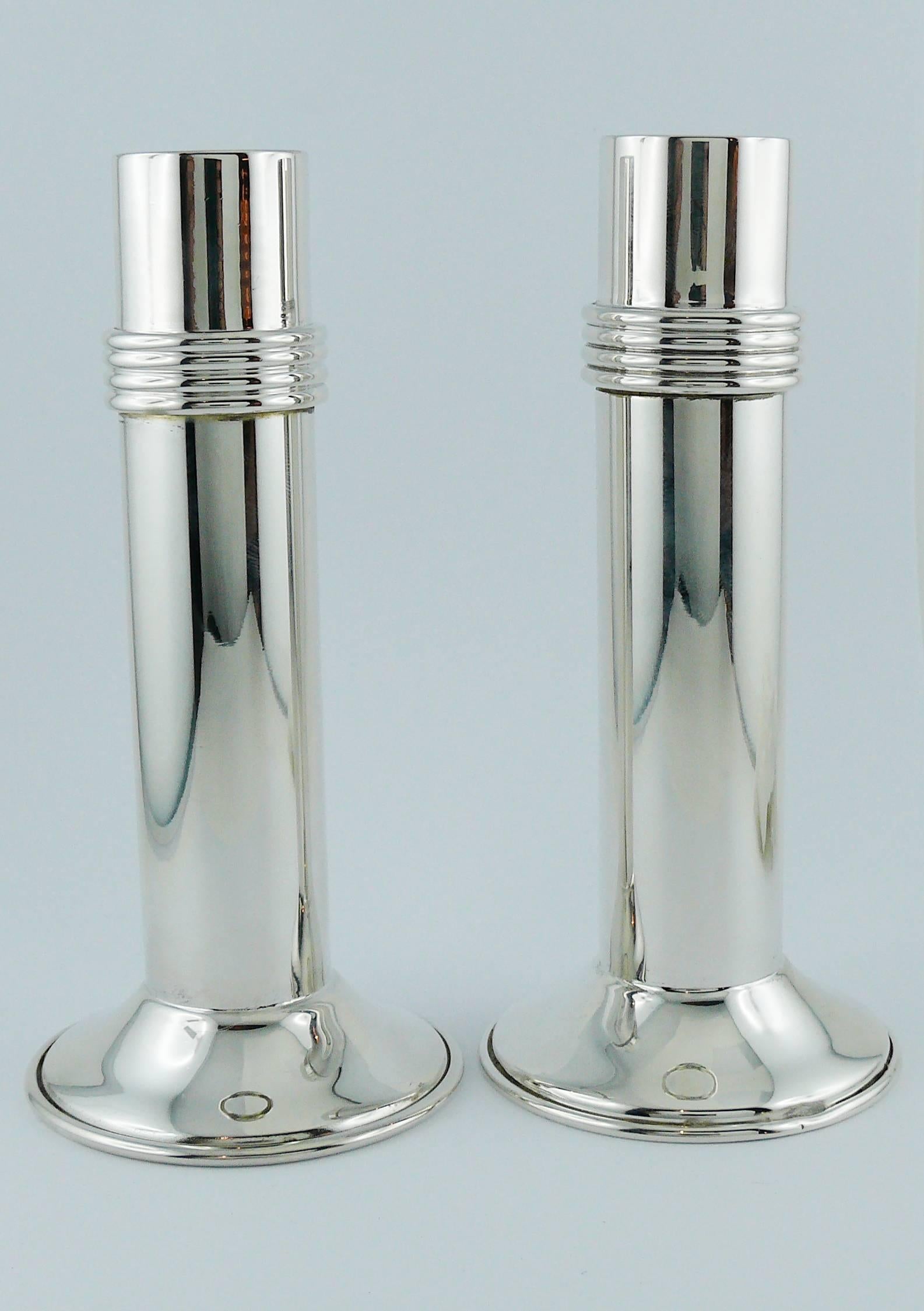 CHRISTIAN DIOR vintage pair of Art Deco inspired candleholders.

These silver plate sophisticated candleholders feature the iconic streamline design with concentric rings and clean lines.

Embossed CHRISTIAN DIOR.
Hallmarked.

Indicative