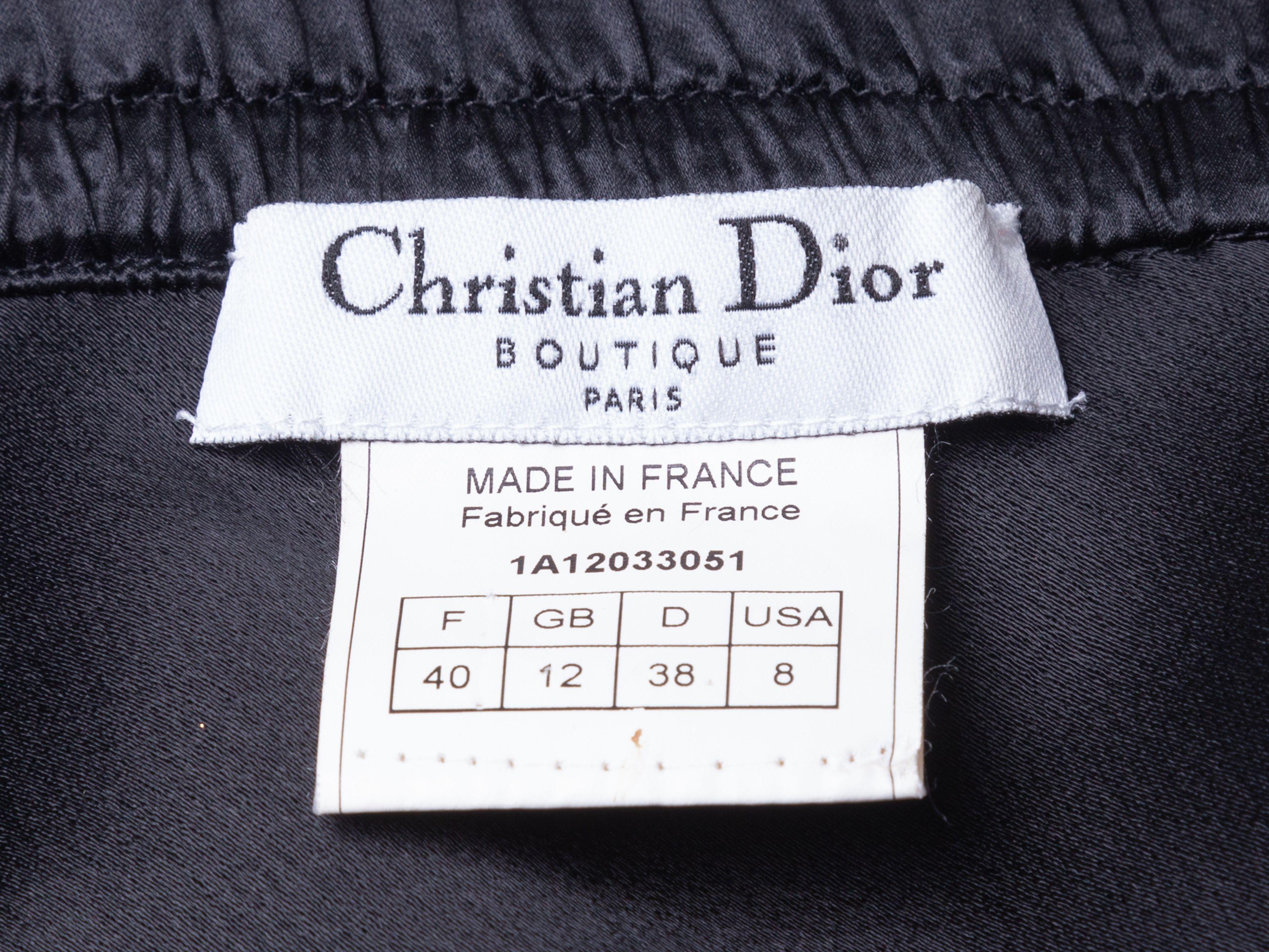 Product Details: Vintage black knee-length skirt by Christian Dior. Satin waistband. Lace trim at hem. Zip and snap closures at side. 27