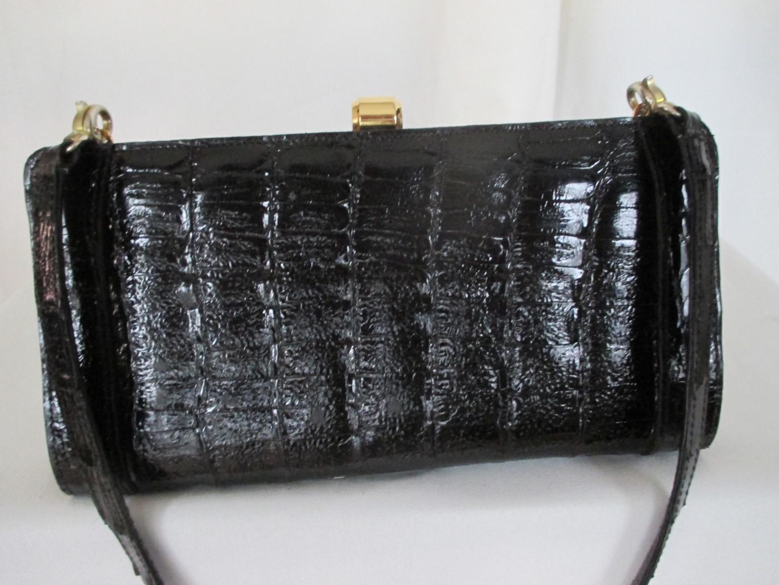 Collectors item!
This rare Dior vintage clutch is made from black crocodile leather with gold-plated hardware.
Inclusive an adjustable strap, 90 cm / 35.43 inch and closes with a clip button in the middle.
The interior is suede leather with a pocket