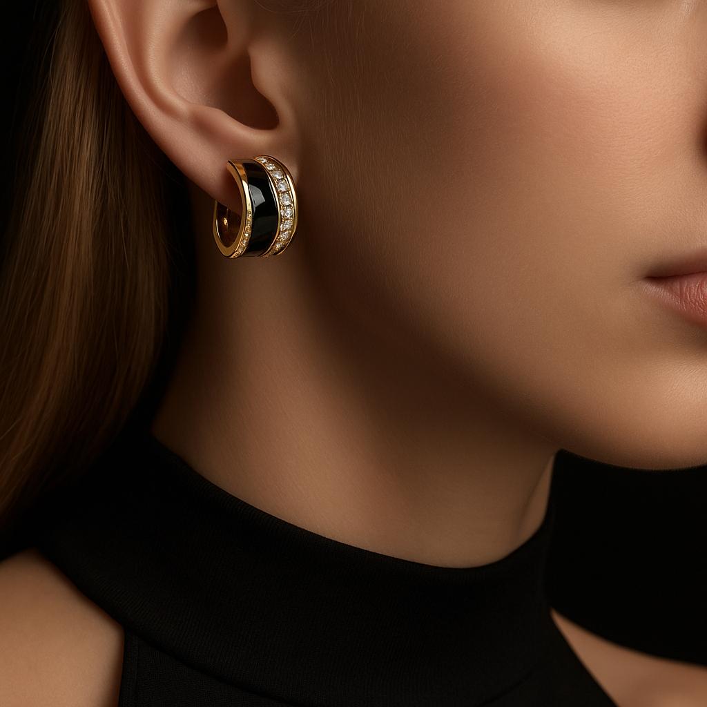 These Christian Dior vintage clip-on earrings are designed with bold black enamel panels set in gold-tone metal and bordered by clear crystals for added sparkle. A classic design from the 1980s, they measure 2.7 cm in length and 1.8 cm in width,