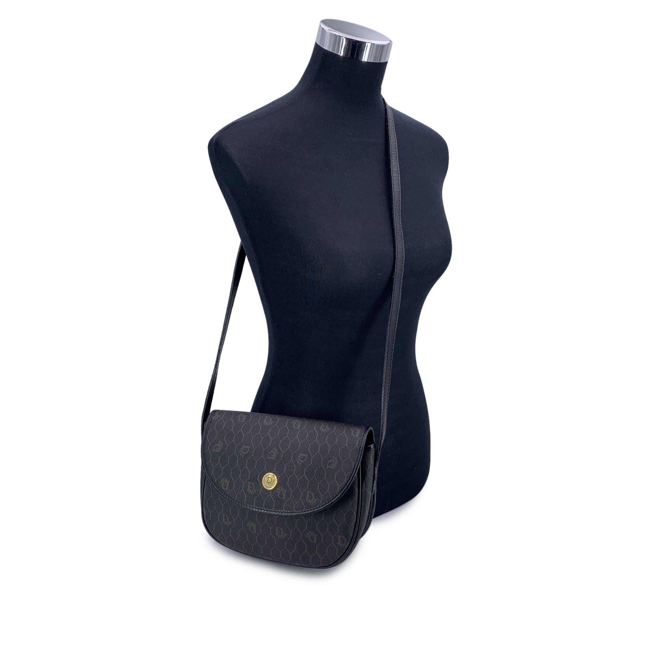 Vintage Christian Dior blak logo canvas small messenger bag with black leather trim and shoulder strap. Gold metal DIOR round tab on the front. Flap with magnetivc button closure. 1 side open pocket inside. 'CHRISTIAN DIOR Paris - Made in France'