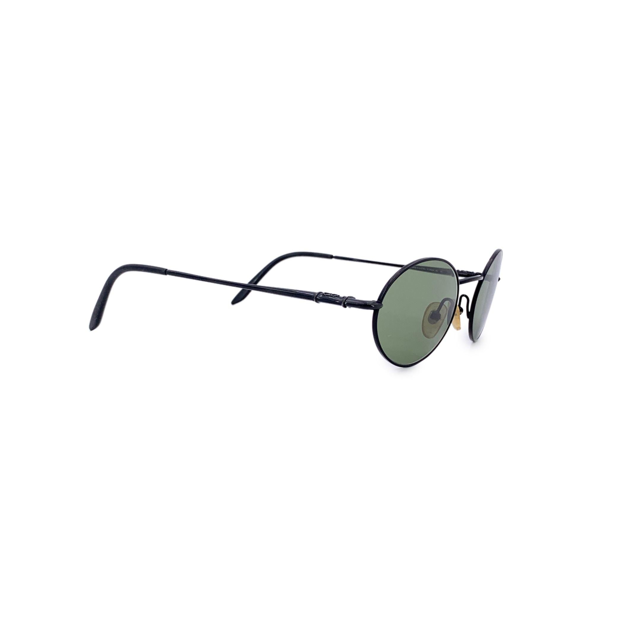 These vintage Christian Dior sunglasses, model CD 2053/N - 70B - 140 - 51/19, are a sleek nod to early 2000s minimalist fashion. Crafted with a refined black metal oval frame, they strike a perfect balance between elegance and edge. The iconic CD