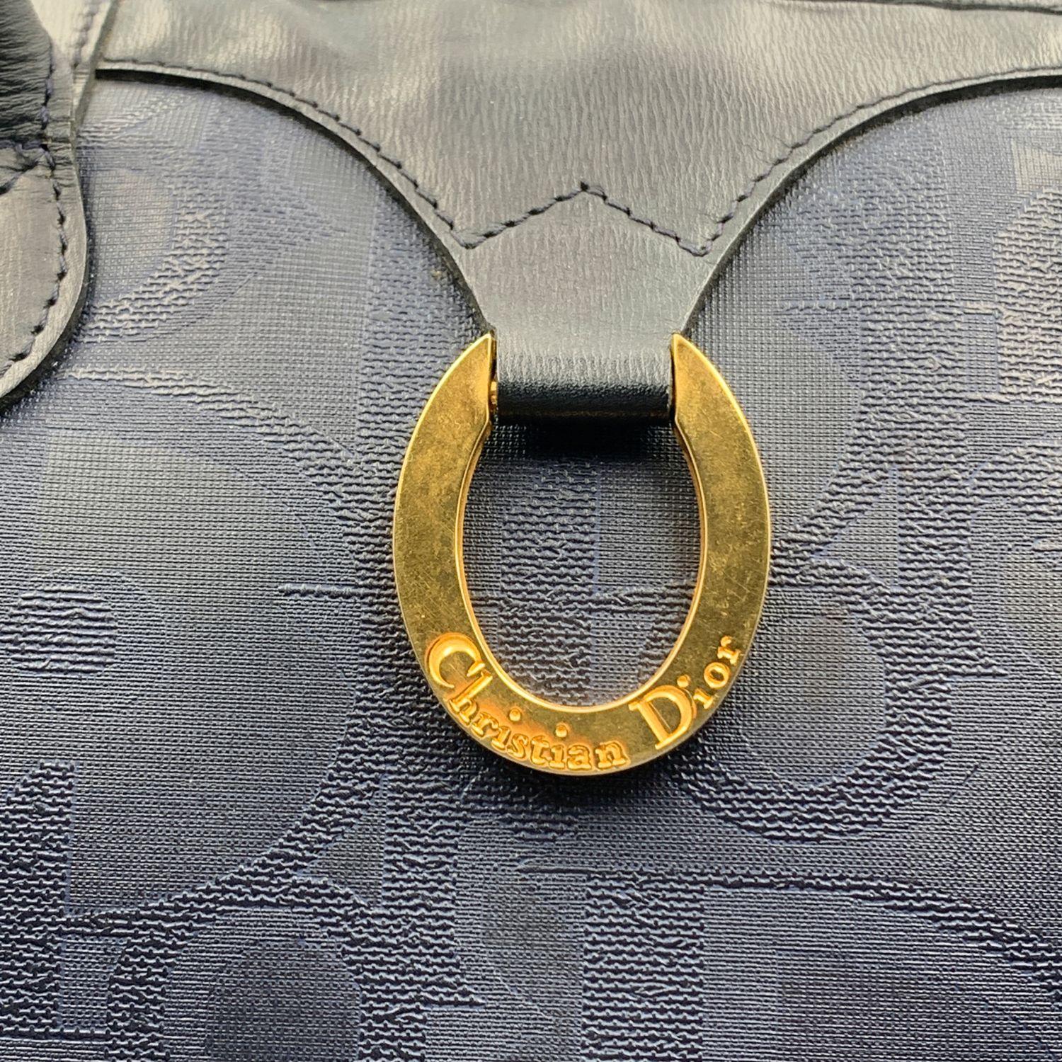 Unisex large vintage weekender duffle bag by Christian Dior. Blue color. Big Dior monogram pattern. Gold metal ring with Dior signature on the front. Top leather handles, no strap. 'Christian Dior, Made in France' 'logo/tag on the inside. Blue