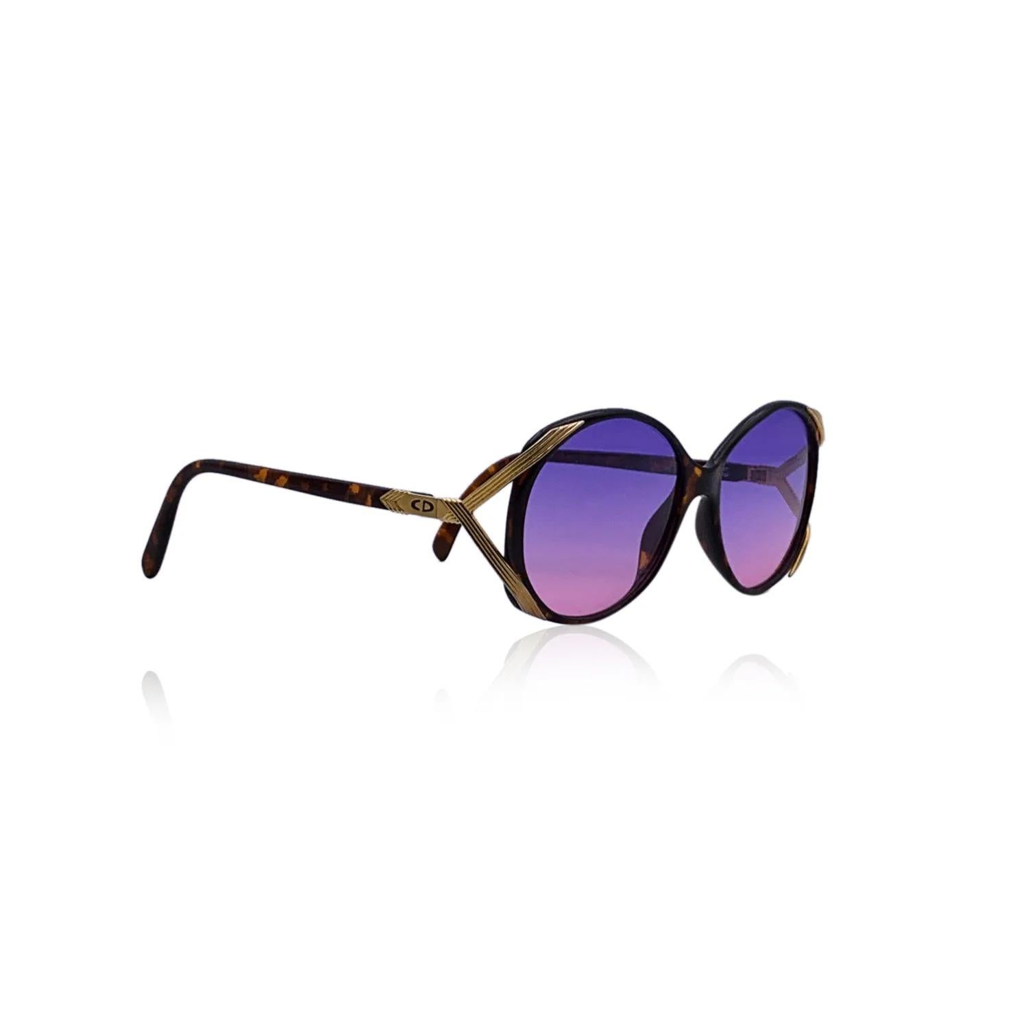CHRISTIAN DIOR Vintage 1980s oval brown tortoise acetate sunglasses with gold metal accents on the sides. Purple gradient lenses. Black acetate arms. Handmade in Germany. CD logo on temples. Mod. & Refs: 2428 - 10 - 56/16. Details MATERIAL: Acetate