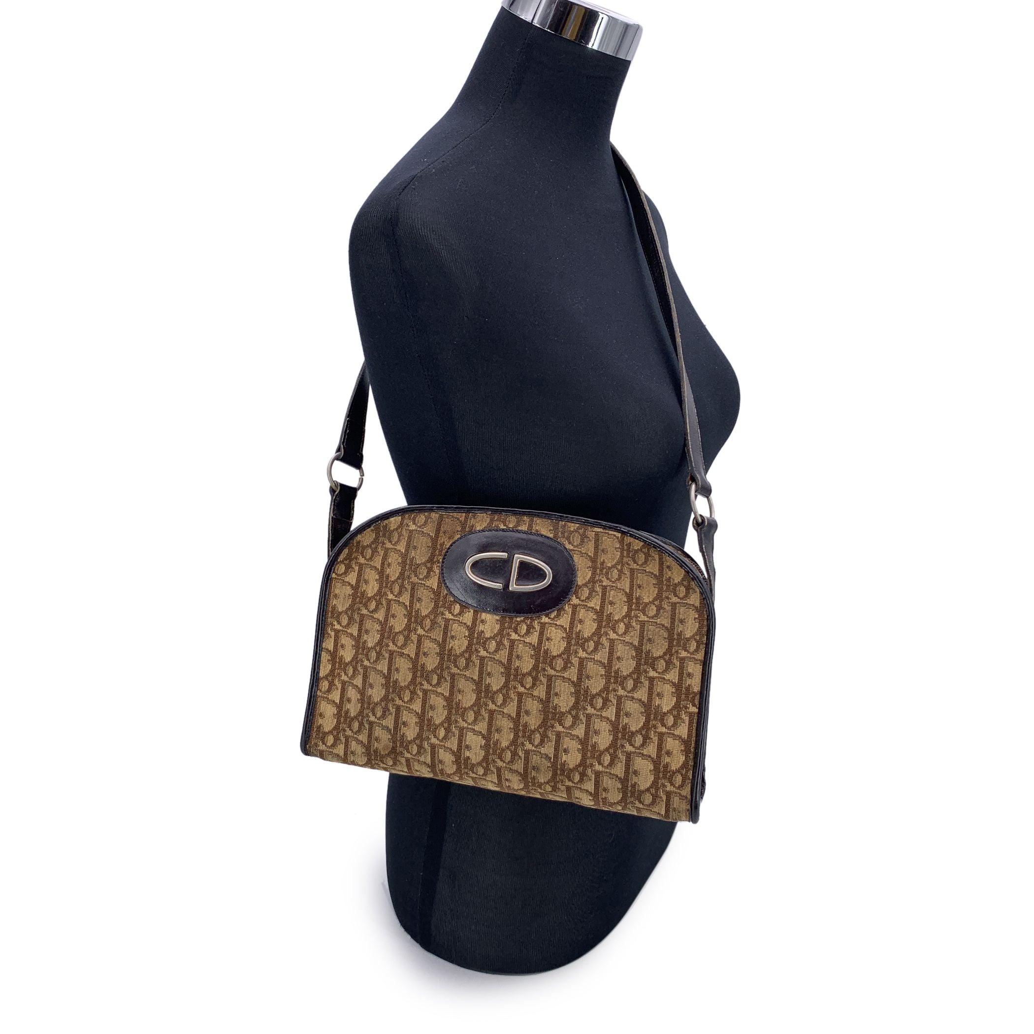 Step back into the golden age of Parisian elegance with this stunning vintage Christian Dior shoulder bag, a timeless treasure from the iconic house. Crafted in the signature brown oblique monogram canvas and framed with rich brown genuine leather