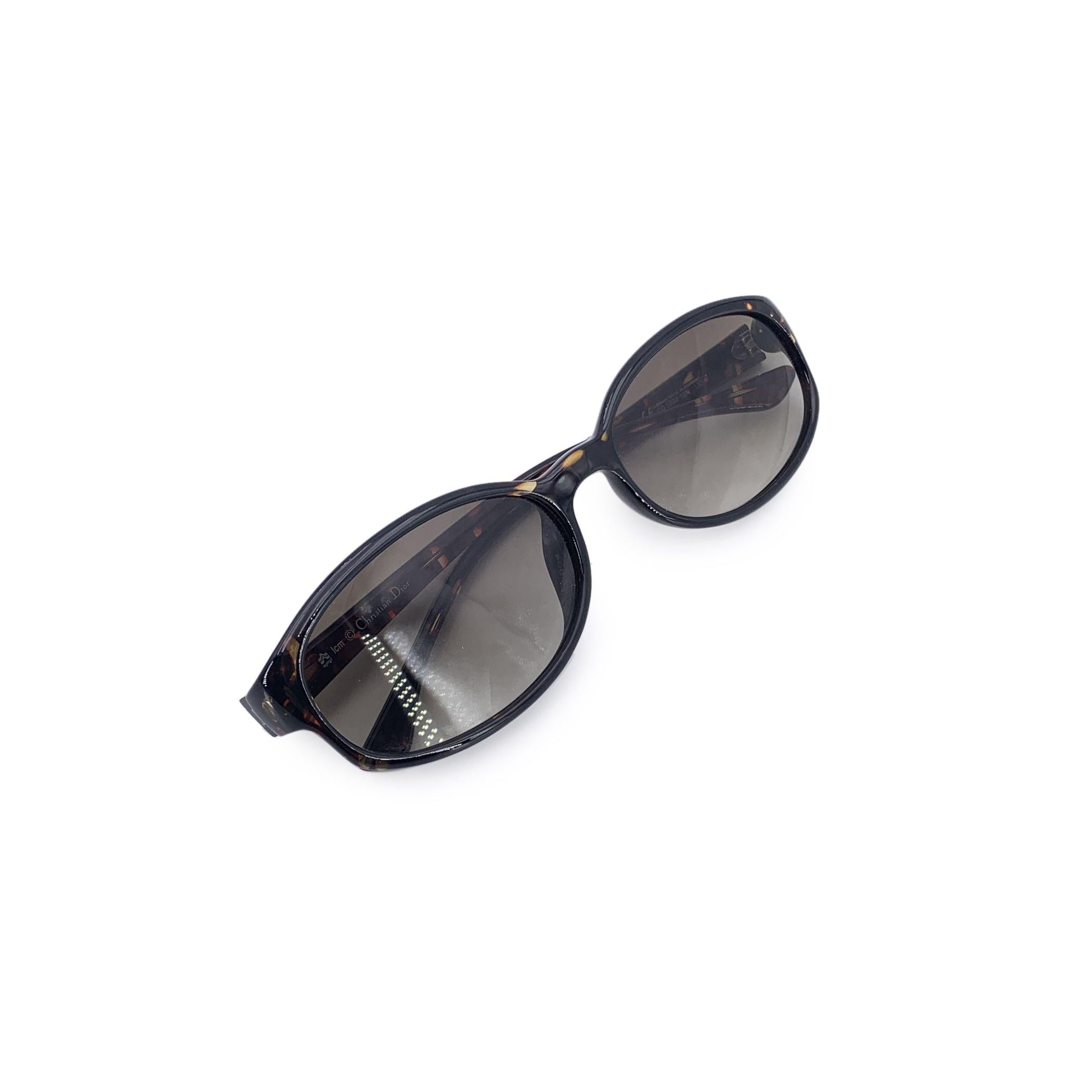 From the softly tinted world of 1980s fashion, these Christian Dior vintage brown sunglasses emerge as a subtle yet striking treasure. With their oval-shaped lenses and warm brown plastic frame, they reflect Dior's flair for understated