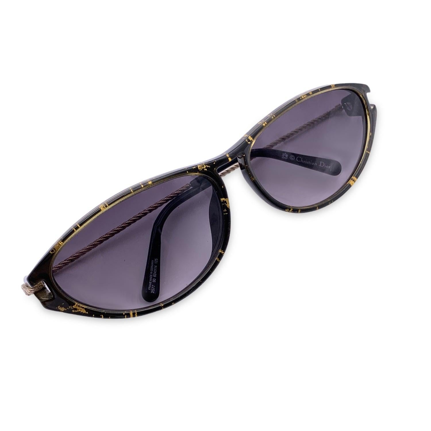 Vintage Christian Dior sunglasses, Mod. 2577 90 Optyl. Size: 60/14 125mm. Brown and gold acetate cat eye frame with gold metal ear stems. Original 100% Total UVA/UVB protection lenses in brown color. CD logo on temples. Details MATERIAL: Plastic