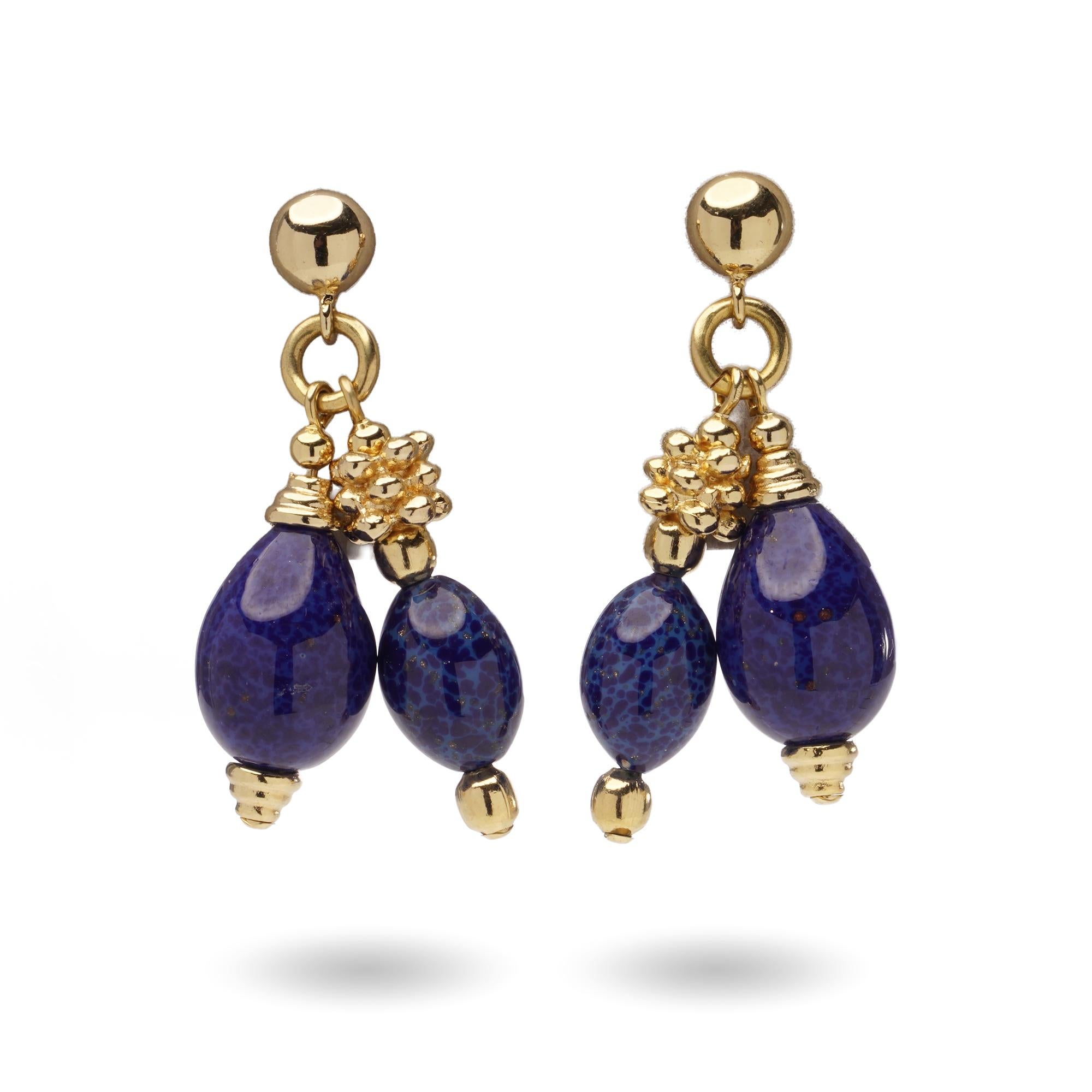 A striking pair of Christian Dior vintage drop earrings, crafted in gold-tone metal and set with bold blue glass beads. Featuring a stud fastening for secure wear. The vibrant blue beads add a rich splash of colour, making them the perfect vintage