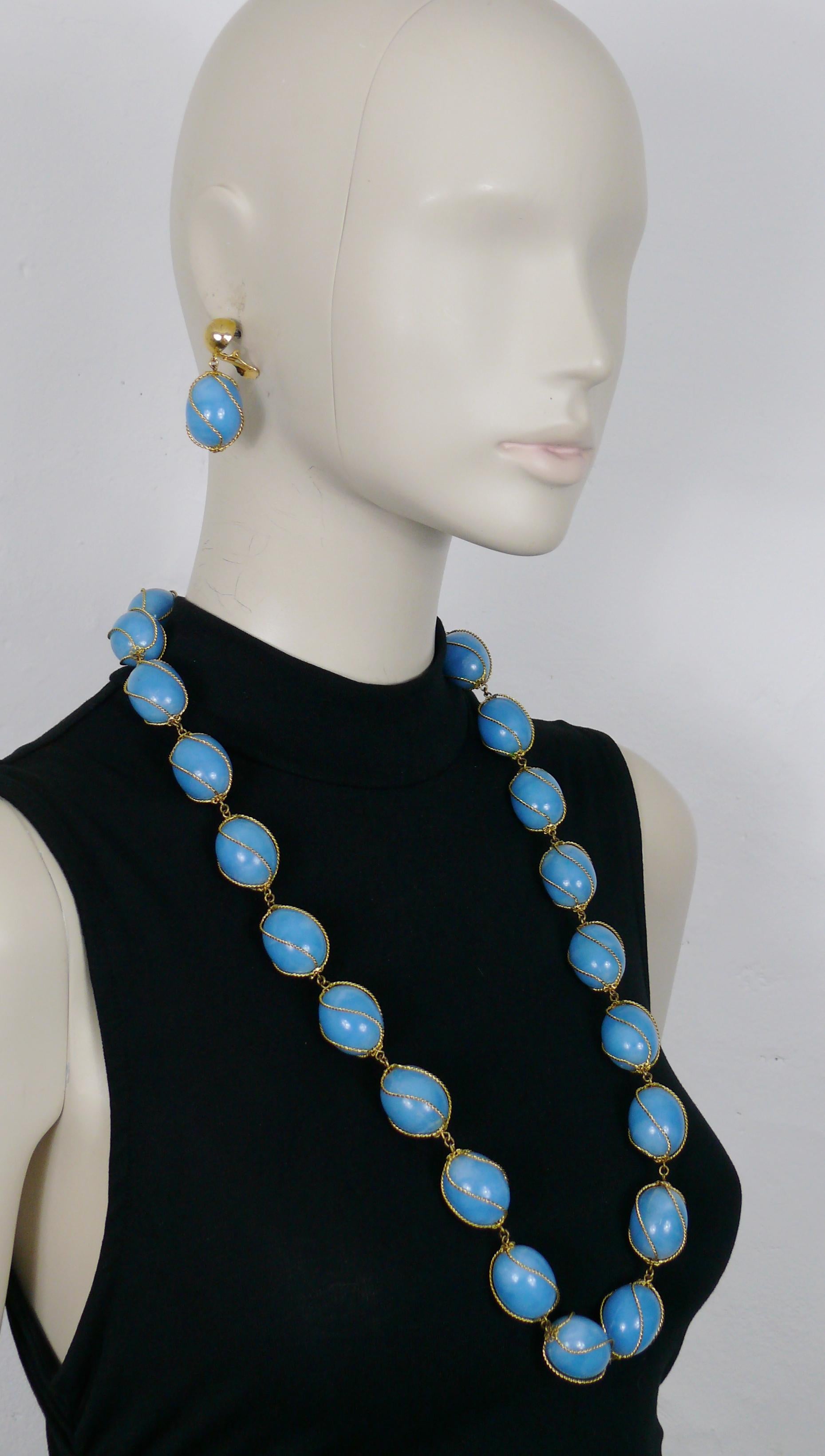 CHRISTIAN DIOR vintage necklace and dangling earrings (clip-on) set featuring gorgeous links made of large olive shaped marbled blue resin beads encaged in a gold toned setting.

Embossed  CHR. DIOR 1966 GERMANY on the reverse of the earrings.
The