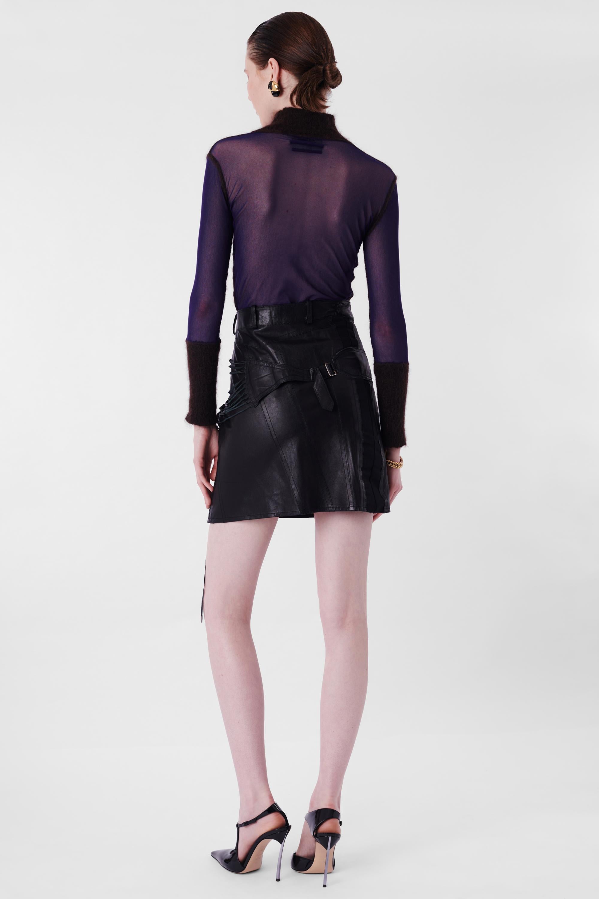 Christian Dior by John Galliano F/W 2003 Black Leather Bondage Mini Skirt. Features lace up side body and bondage detail on hips, zipper and button for closure in mini length. In excellent vintage condition.

Brand: Christian Dior
Size: UK 8
Color: