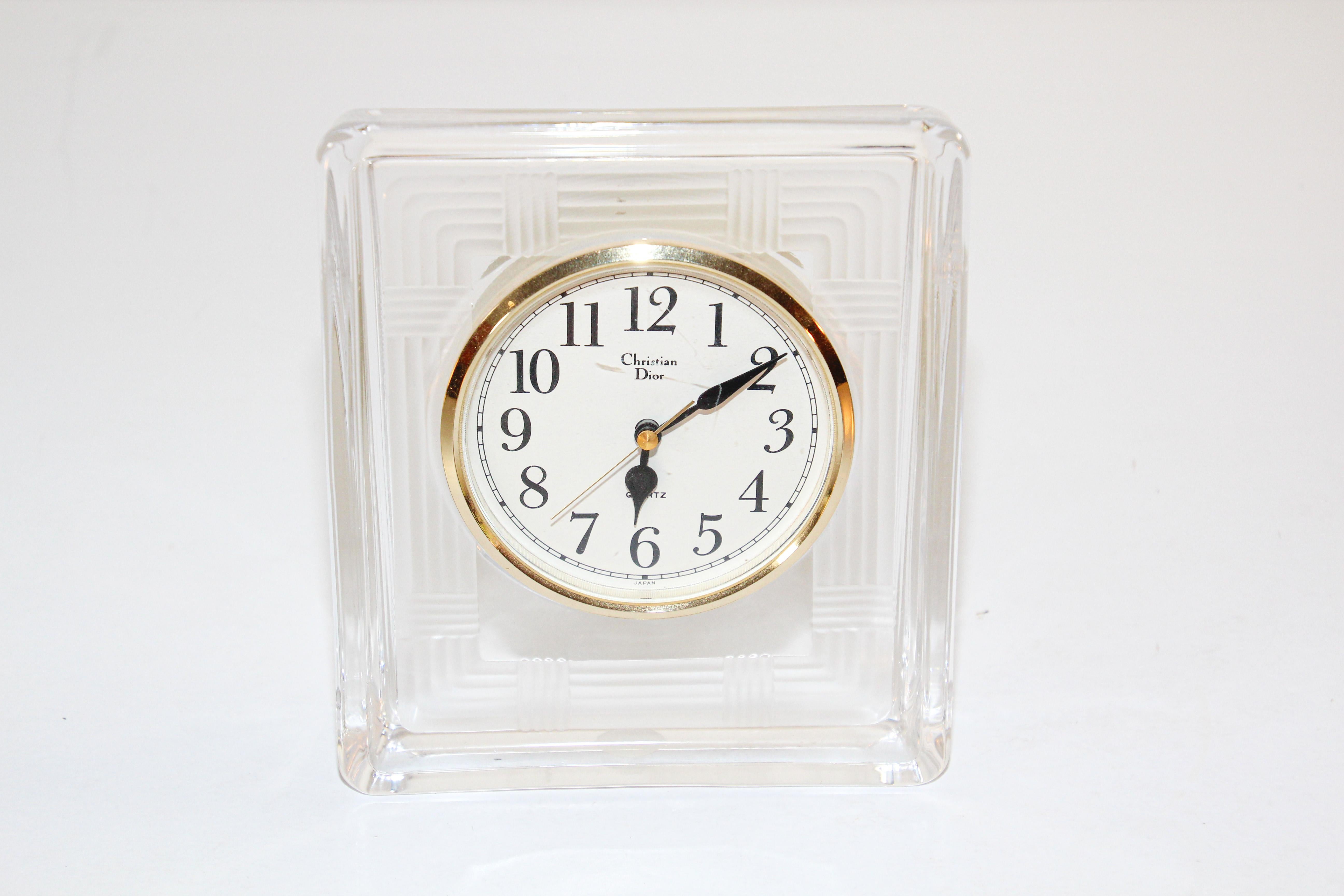 Christian Dior vintage glass desk clock,
A classy, vintage glass and brass desk clock from Christian Dior. The clock is brass with beige background and black numbers. 