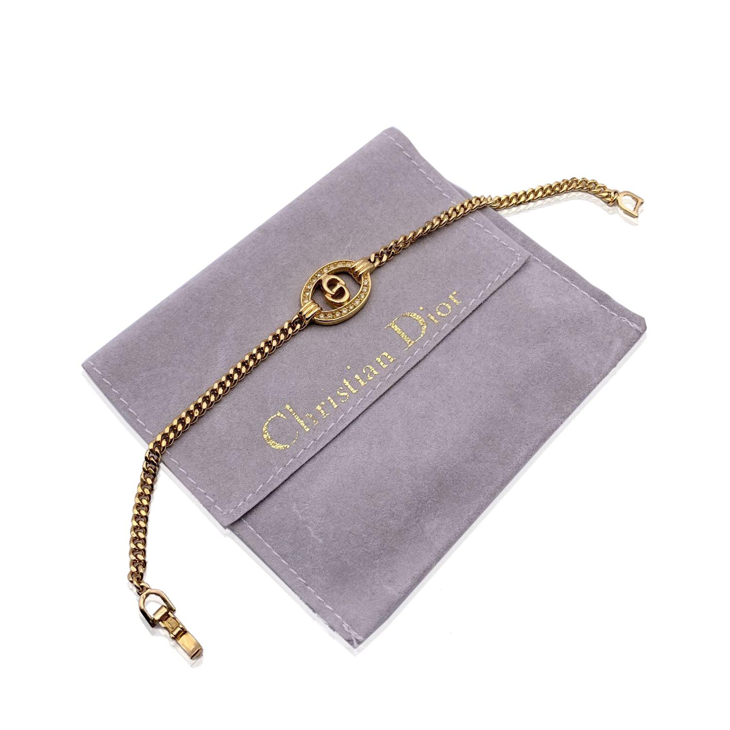 Vintage gold metal chain bracelet by CHRISTIAN DIOR. Oval CD logo element with rhinestones in the center. Spring ring closure. Internal circumference: 7 inches - 17.8 cm. 'Chr. Dior' engraved on the closure. Condition A - EXCELLENT Gently used.