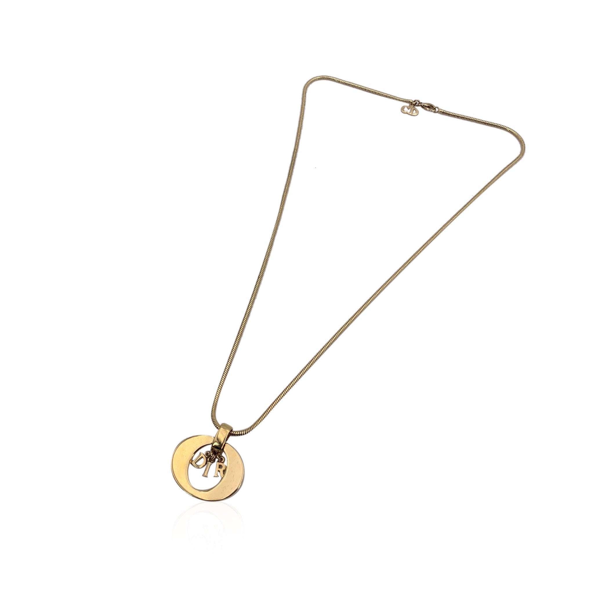 A chic nod to early 2000s glamour, this Christian Dior gold metal necklace is a vintage-inspired statement that captures the spirit of the house's playful elegance. At its heart is a bold oval ring pendant, delicately showcasing the iconic dangling