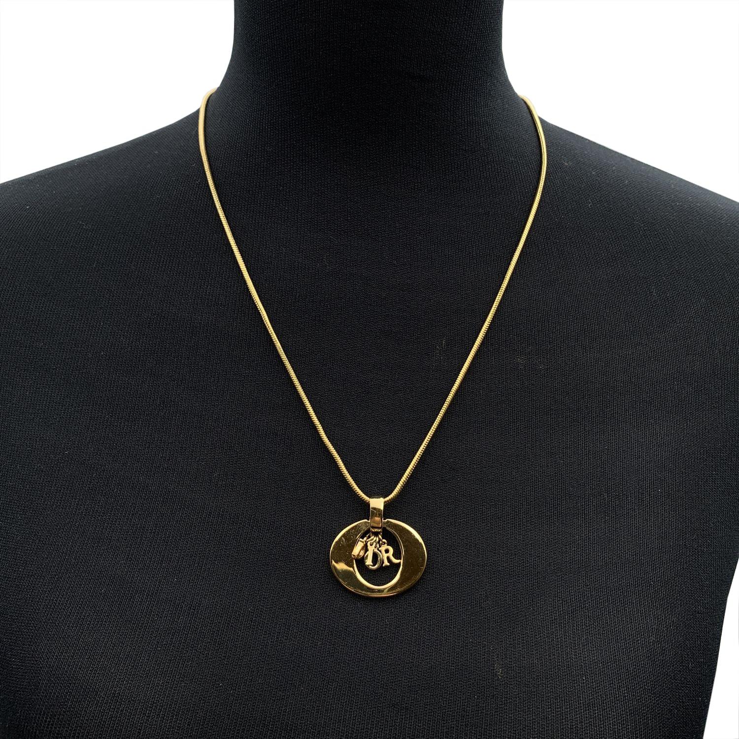 Christian Dior gold metal necklace. Oval ring pendant with dangling D.I.O.R. letters in the center. Rat tail chain. Lobster closure. Chain length: about 21 inches - 53.3 cm Condition A - EXCELLENT Gently used. Minimal scratches on the surface of the