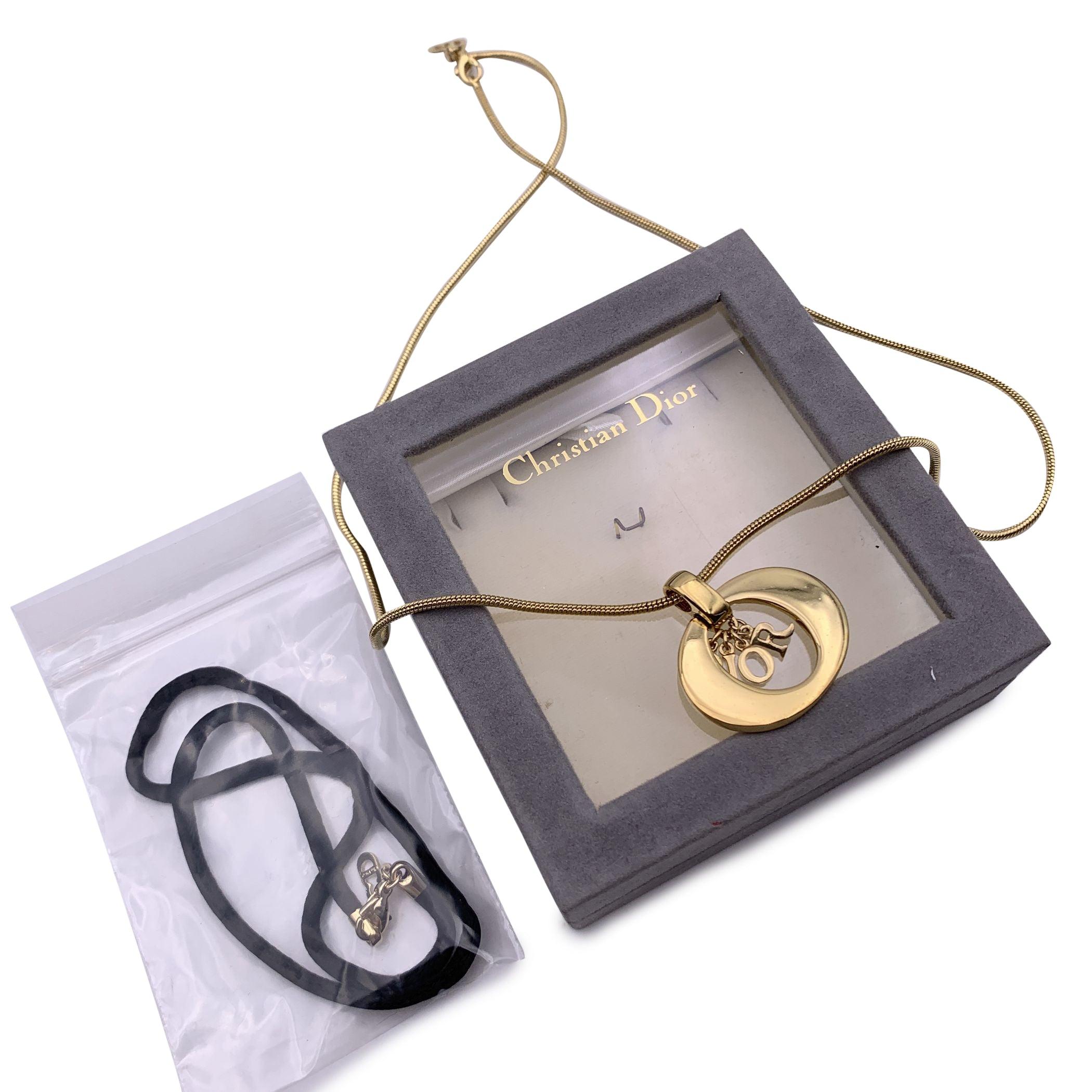 Christian Dior gold metal necklace. Oval ring pendant with dangling D.I.O.R. letters in the center. Rat tail chain. Lobster closure. Chain length: about 21.5 inches - 54.6 cm. Extra-satin cord included (lenght: 14.5 inches - 36.8 cm) Condition A -