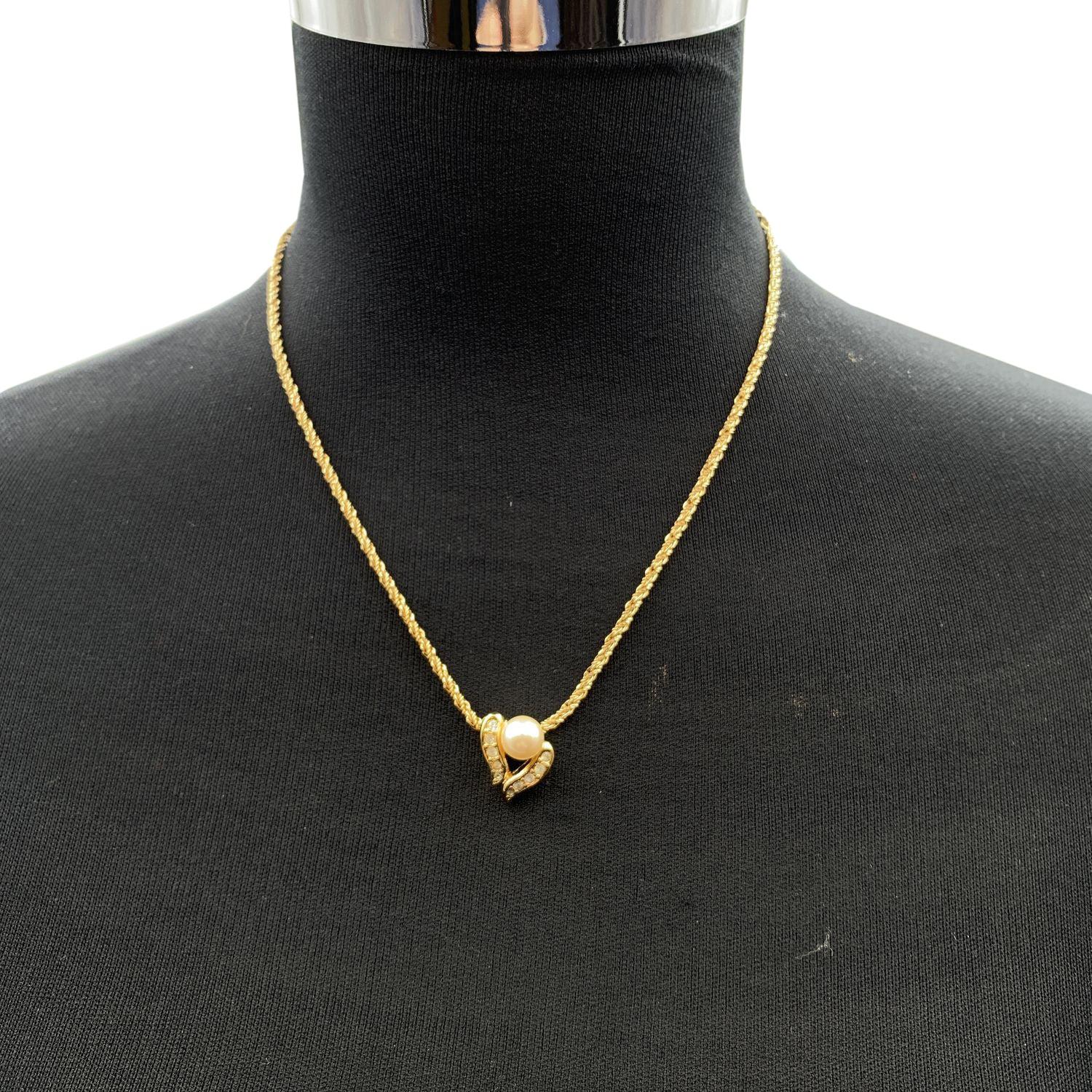 Vintage Christian Dior gold metal chain necklace. Zen style, soothing shape, this pendant is mounted with a pearl, gold metal elements with cystal embellishment (marked Dior on its reverse). Lobster closure. CD small charm at the end of the chain.