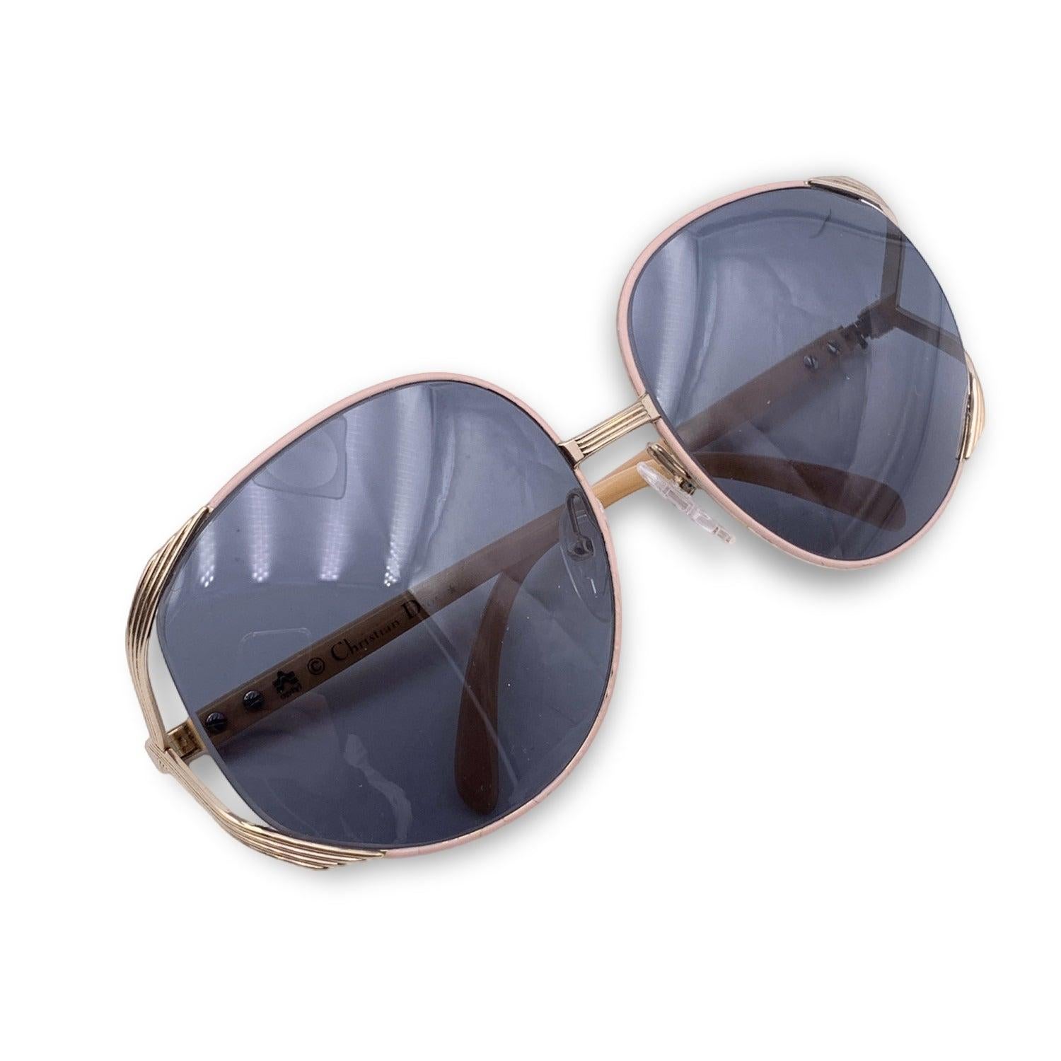 Vintage Christian Dior sunglasses, Mod. 2250. Gold metal frame with baby pink enameled details. Original 100% Total UVA/UVB protection in grey color. CD logo on temples. Pink Optyl ear stems. Details MATERIAL: Metal COLOR: Pink MODEL: 2250 GENDER: