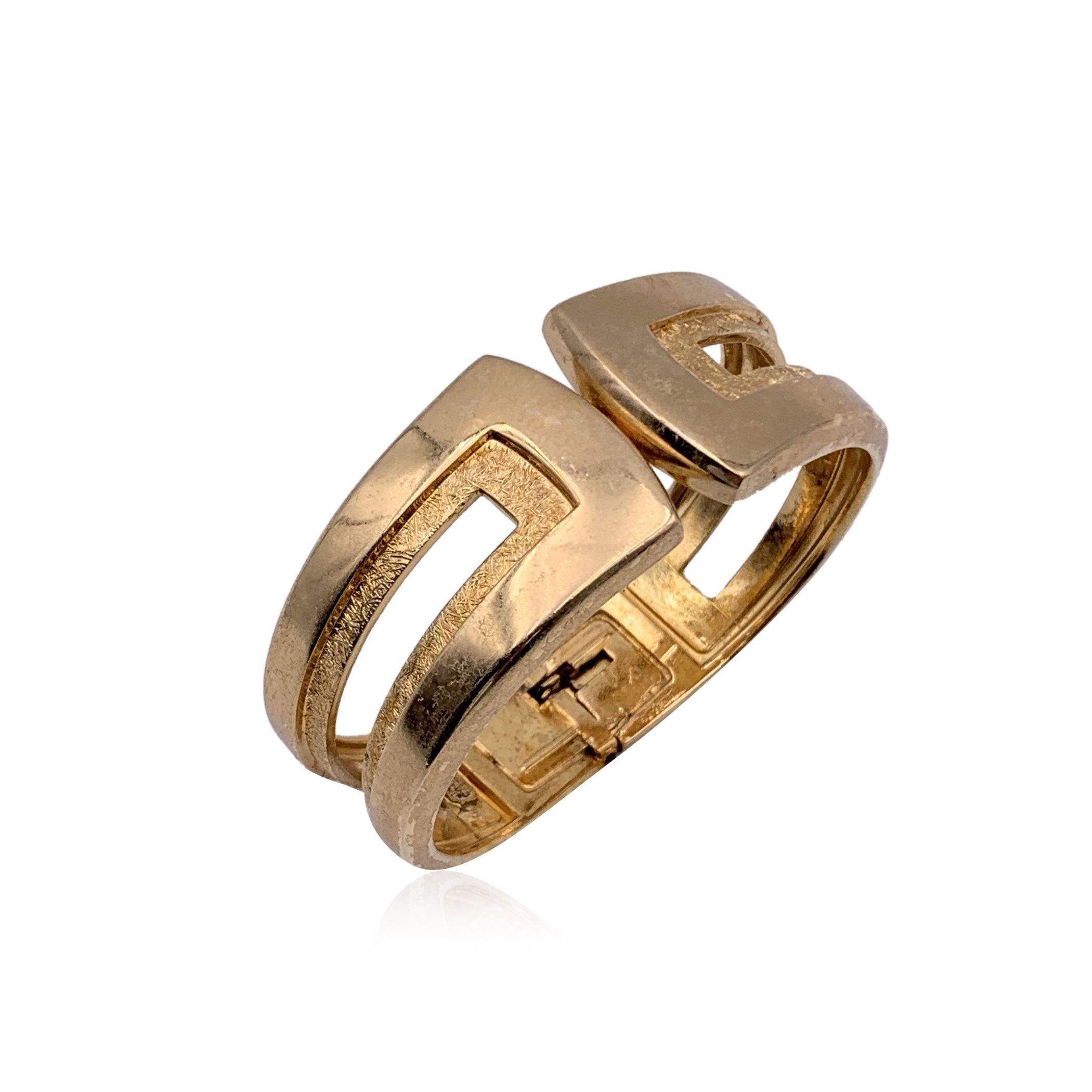 Vintage cuff clamper bracelet by Christian Dior, from the 1970. Gold plated metal. Signed '1972 - Chr.Dior - Germany' internally. Internal circumference: 6.5 inches - 16.5 cm. Height: 30 mm Condition B - VERY GOOD Gently used. Some light scratches