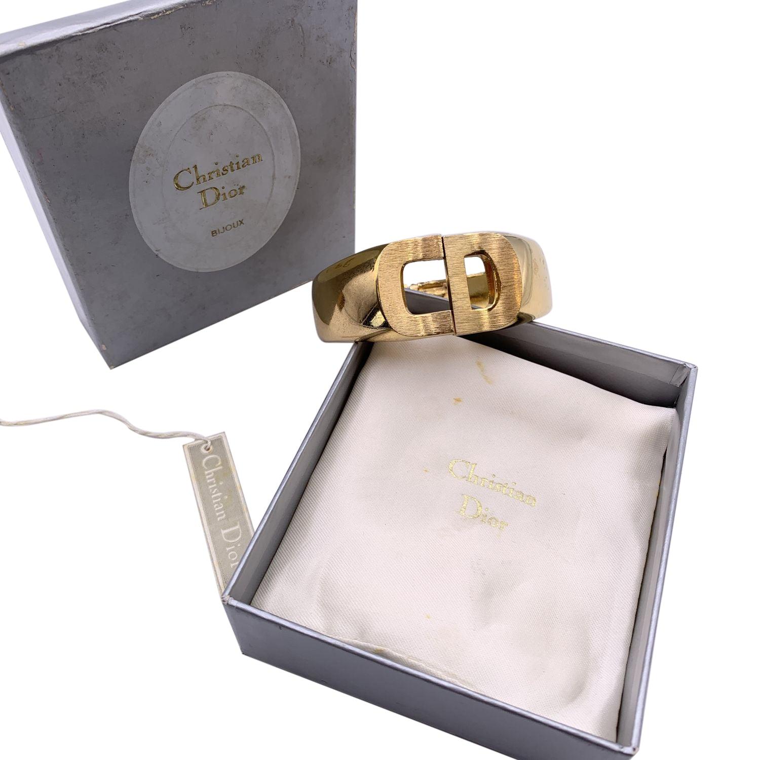 Vintage cuff clamper CD logo bracelet by Christian Dior, from the 1970. Gold plated metal. Signed '1972 - Chr.Dior - Germany' internally. Internal circumference: 7 inches - 17.8 cm. Height: 30 mm Condition A - EXCELLENT Gently used. Please check