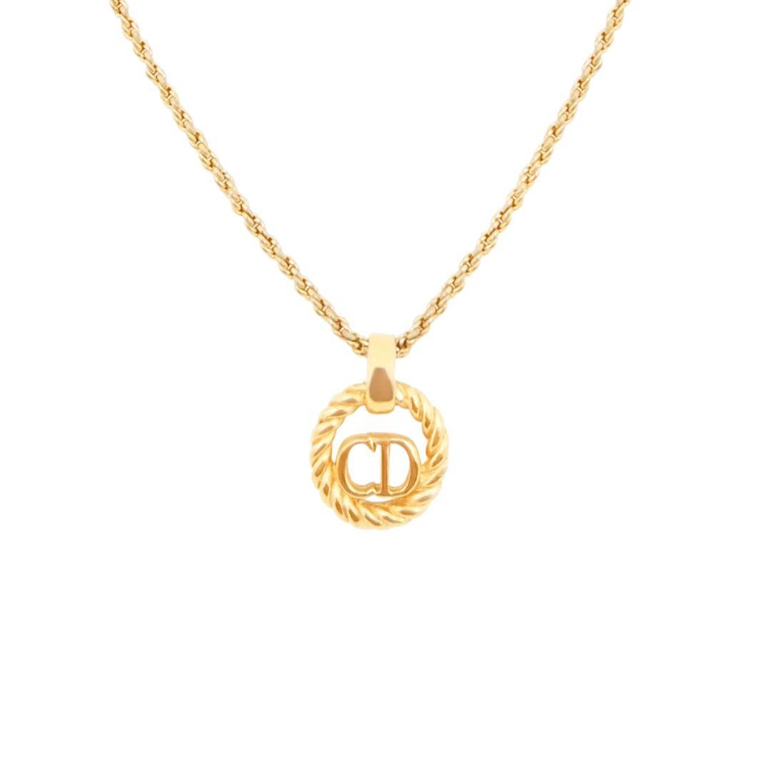 Vintage Christian Dior gold plated circular logo 'CD' pendant chain necklace.

Condition Details: In very good, vintage used condition consistent with its age and use. There are small scratches and wear to the metal which is mostly at the back of