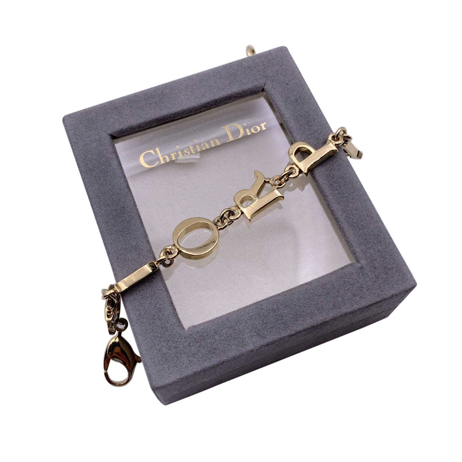 Gold plated metal articulated vintage bracelet by CHRISTIAN DIOR. 'D.I.O.R. P.A.R.I.S' letters initials links. Lobster closure. Internal circumference: 7 inches - 17.8 cm. Condition A - EXCELLENT Gently used. Please check pictures carefully and ask