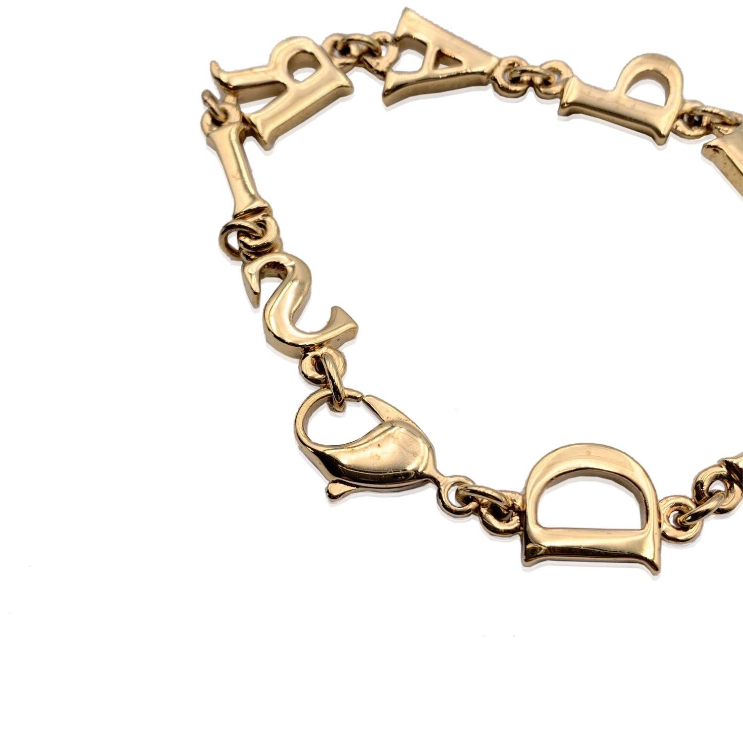 Gold plated metal articulated vintage bracelet by CHRISTIAN DIOR. 'D.I.O.R. P.A.R.I.S' letters initials links. Lobster closure. Internal circumference: 7 inches - 17.8 cm. Condition A - EXCELLENT Gently used. Please check pictures carefully and ask