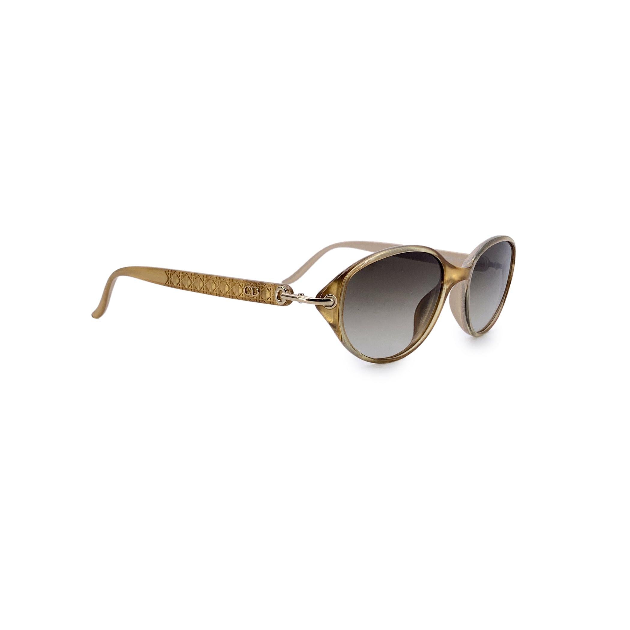 A shining reflection of 1980s elegance, these Dior vintage gold sunglasses, model CD 3005, embody the sophisticated glamour that defined the era. With their gently oval lenses and shimmering gold-toned plastic frame, they strike the perfect balance