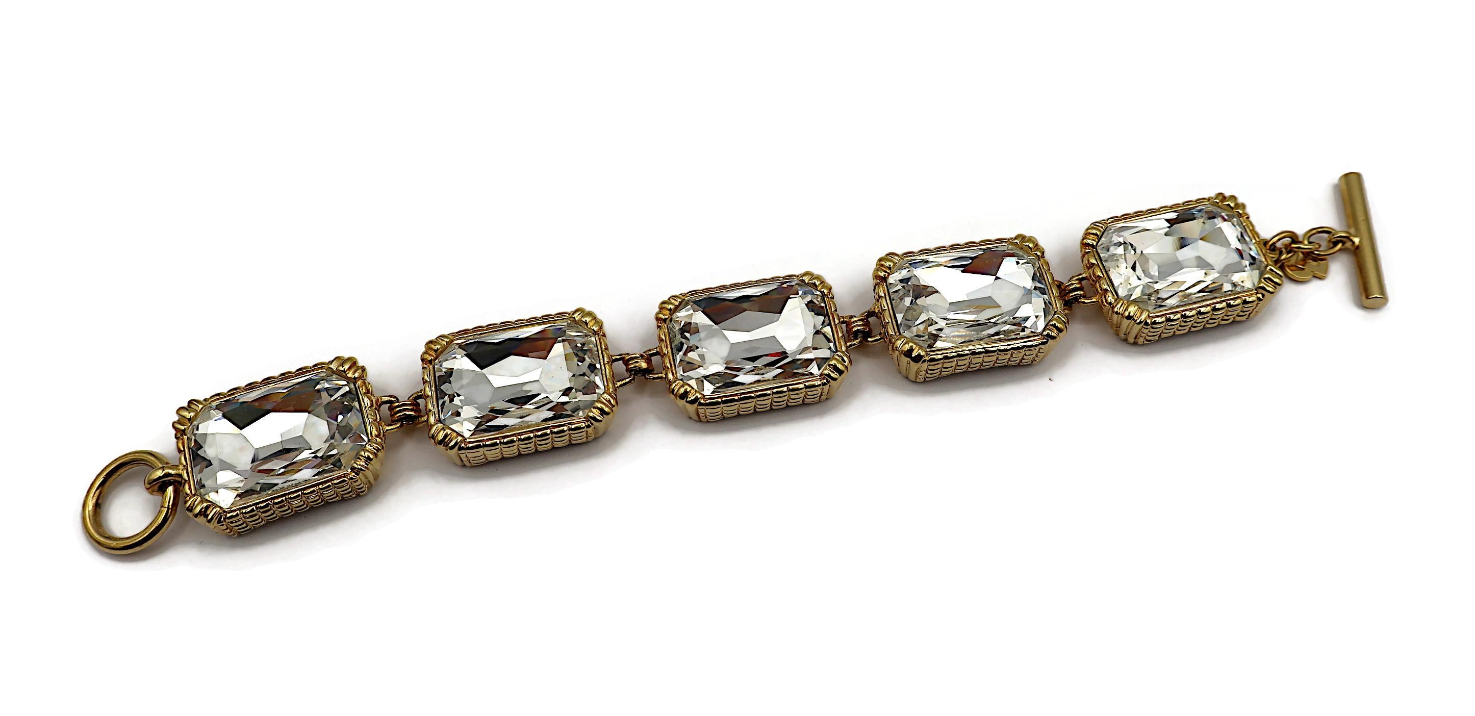 CHRISTIAN DIOR vintage gold tone rectangular link bracelet embellished with massive clear crystals.

T-bar and toggle closure.

Embossed CHR. DIOR Germany.

Indicative measurements : length approx. 22 cm (8.66 inches) / width approx. 2.4 cm (0.94