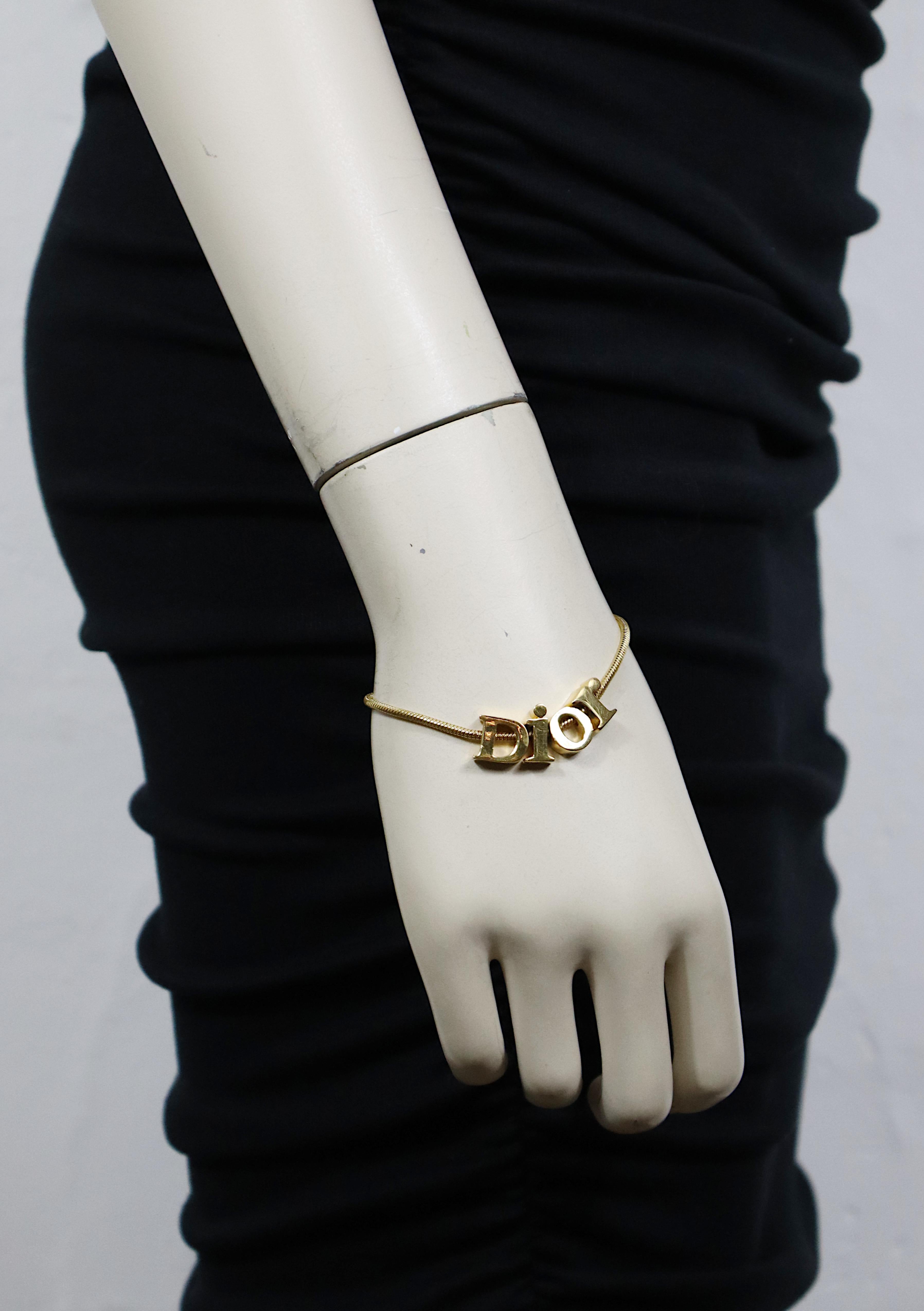 CHRISTIAN DIOR vintage gold tone snake chain bracelet featuring a spellout DIOR logo.

Lobster clasp closure.

Embossed DIOR.

Indicative measurements : length from approx. 17.5 cm (6.89 inches) to approx. 19 cm (7.48 inches) / max. width approx.