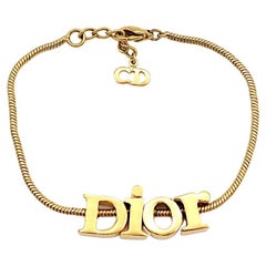 CHRISTIAN DIOR Vintage Gold Tone Spellout Bracelet