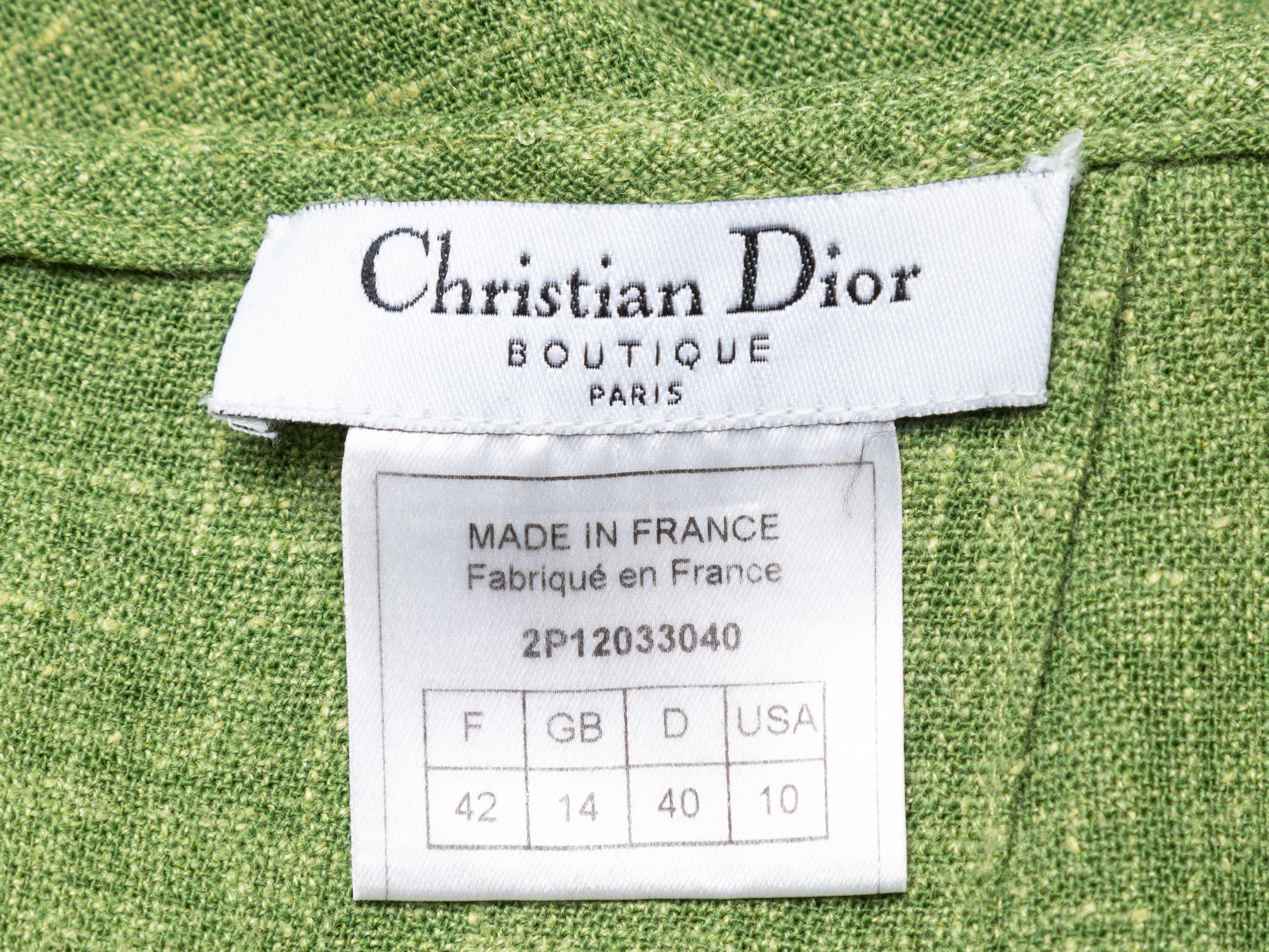 Product Details: Vintage green linen and tan leather knee-length skirt by Christian Dior. Dual patch pockets at front. Vent at front hem. Zip closure at center back. 28