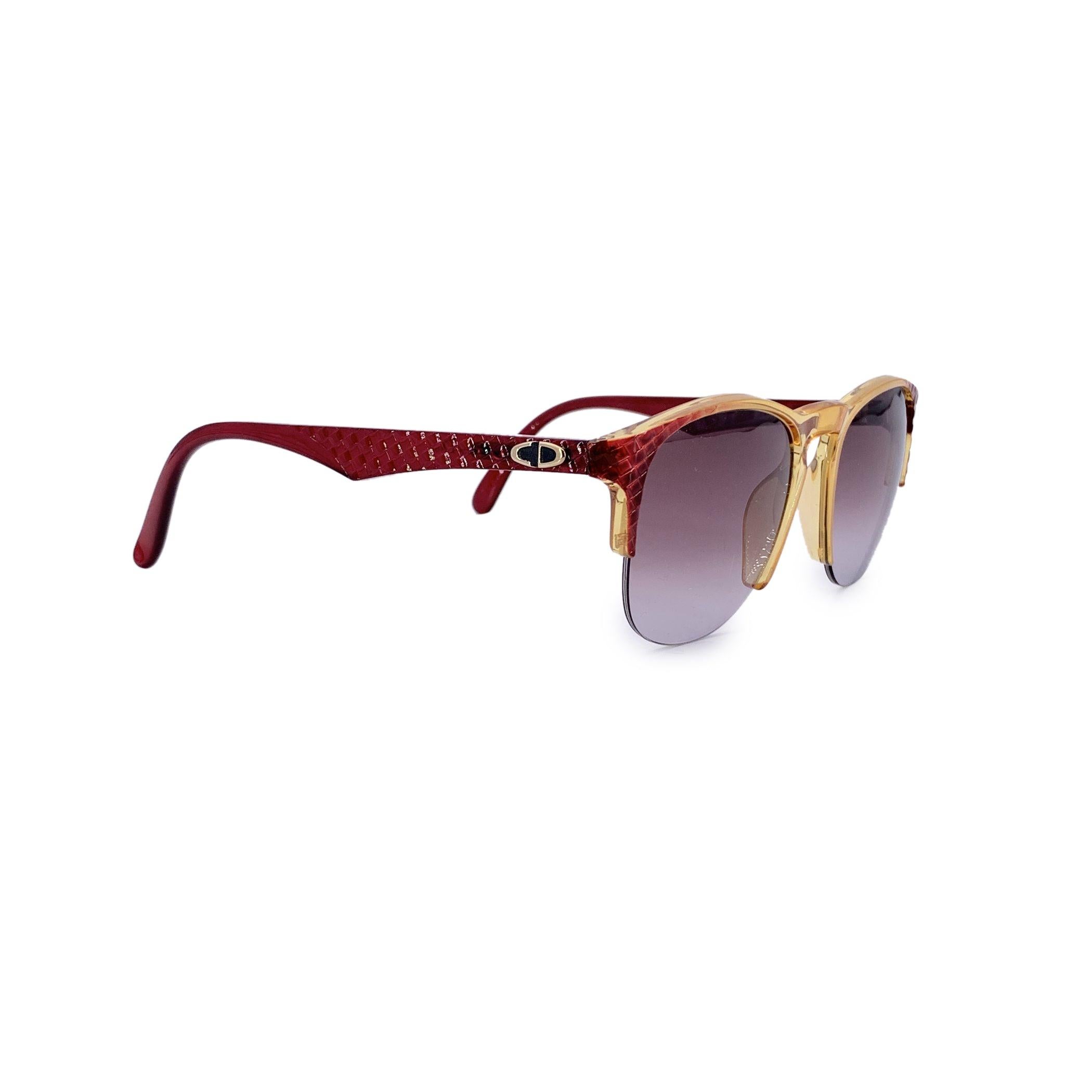 Bold and unmistakably retro, these vintage Christian Dior women's sunglasses (Model 2376 30 Optyl) are a dazzling tribute to the glamour of past decades. Crafted in Germany from lightweight Optyl, the yellow and red acetate half-rim frame makes a