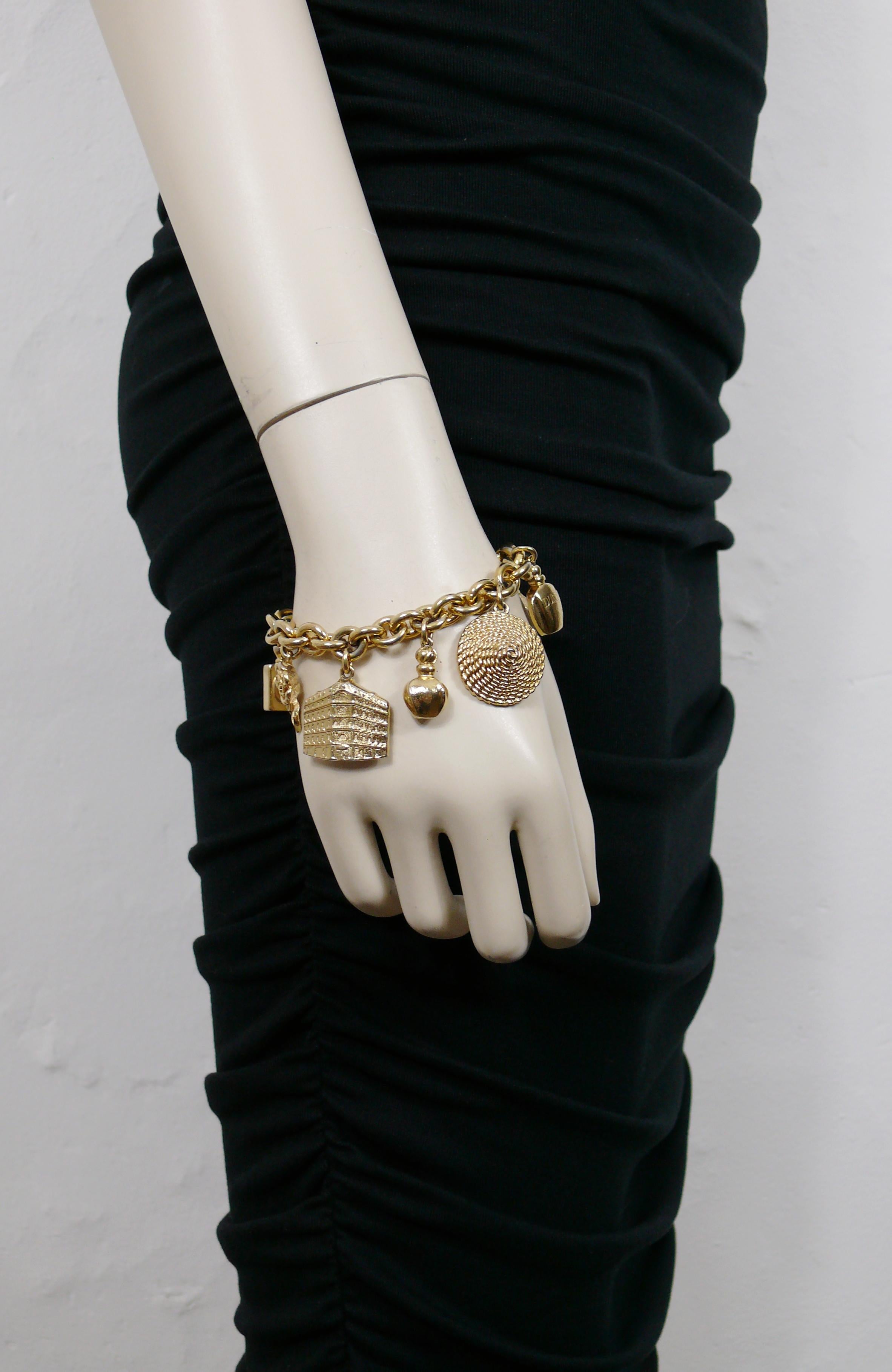 CHRISTIAN DIOR vintage iconic gold toned chain bracelet featuring eight iconic charms : rose, C DIOR logo, 3 perfume bottles, flagship facade, New Look straw hat, gift box with CD monogram.

T-bar and toggle closure.

Embossed CHR. DIOR