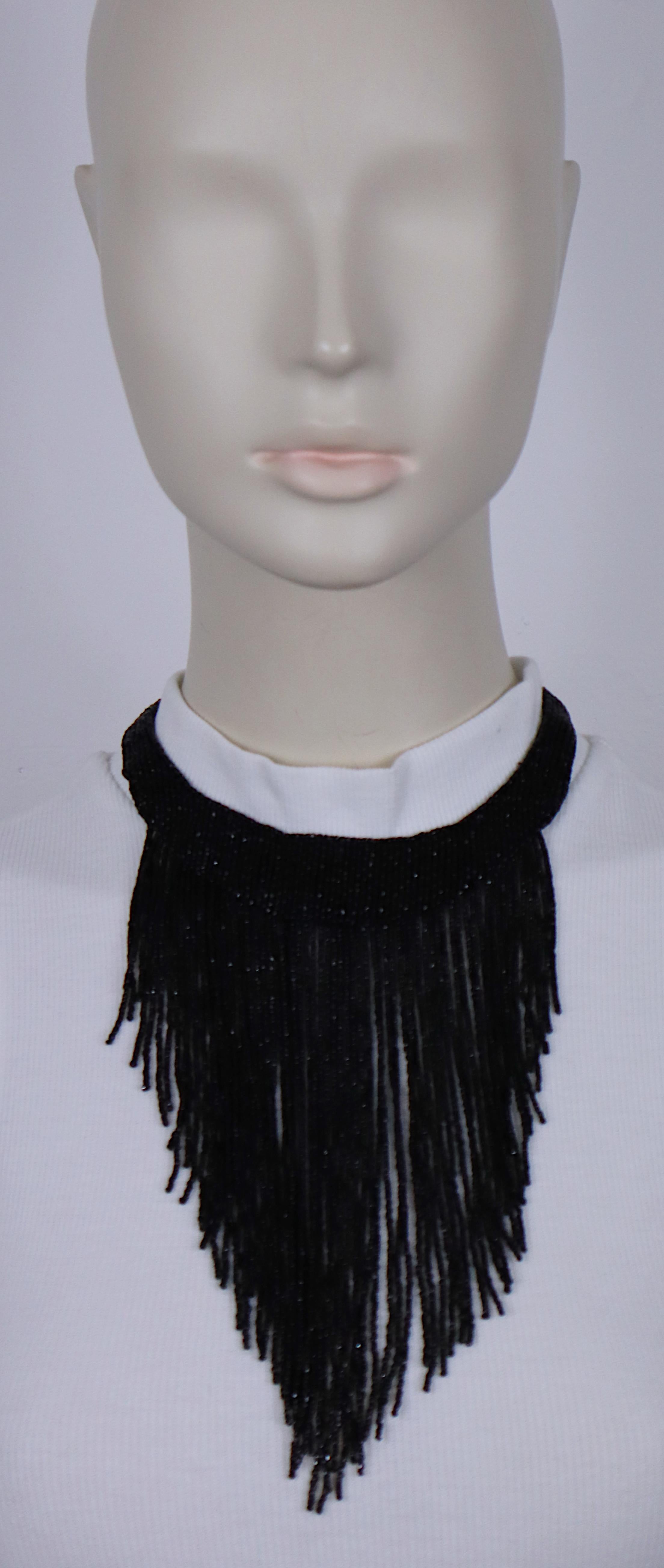 CHRISTIAN DIOR vintage waterfall necklace inspired by the 1920s made of cascading fringes of jet black beads.

Silver tone hardware.

Fold-over clasp embellished with clear crystals.

Embossed DIOR.

Indicative measurements : length approx. 37 cm