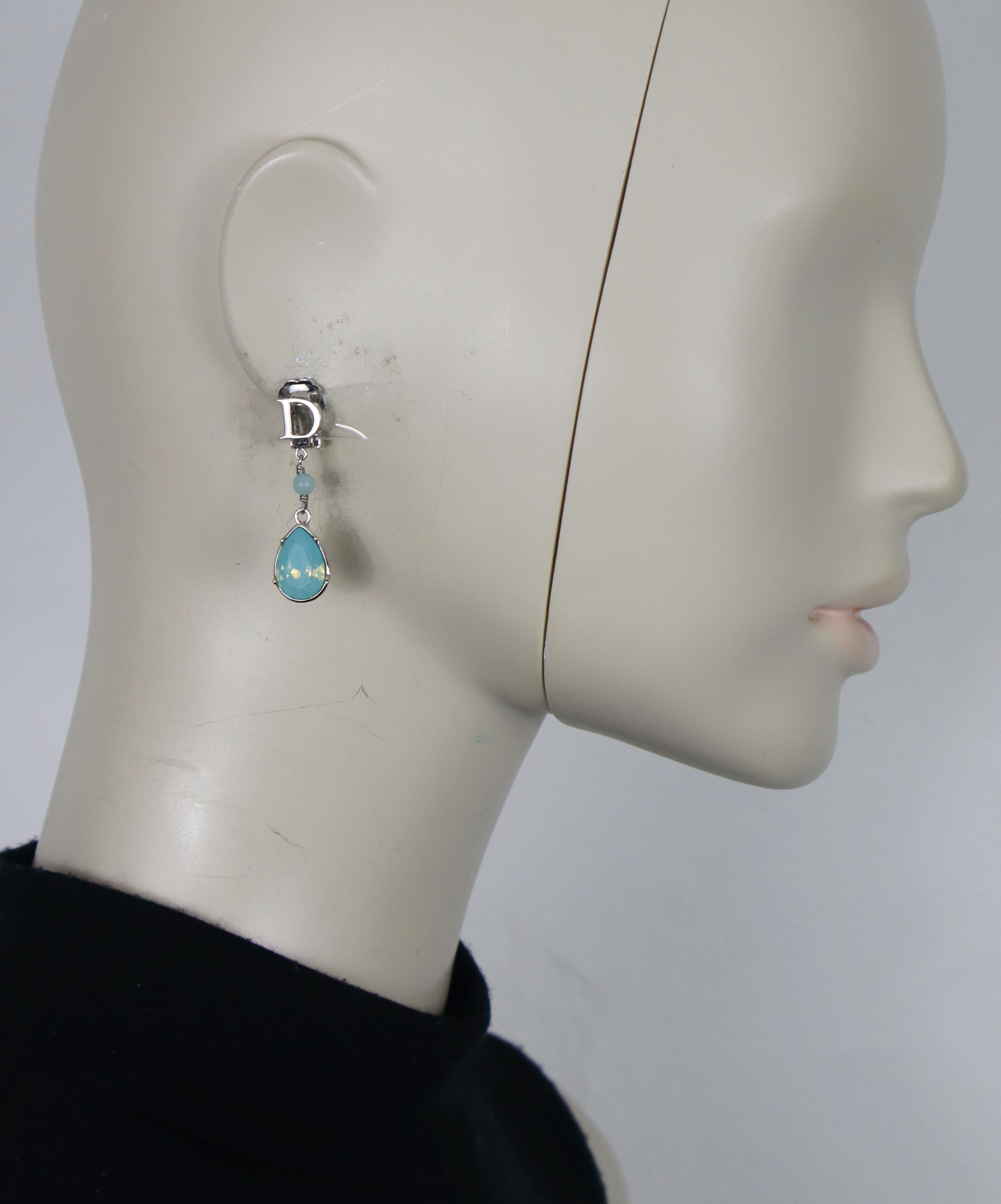 CHRISTIAN DIOR vintage silver tone D dangling earrings (clip-on) embellished with a blue opalescent bead and crystal drop.

Cruise collection 2008.

Embossed DIOR.

Indicative measurements : height approx. 3.8 cm (1.50 inches) / max width approx. 1
