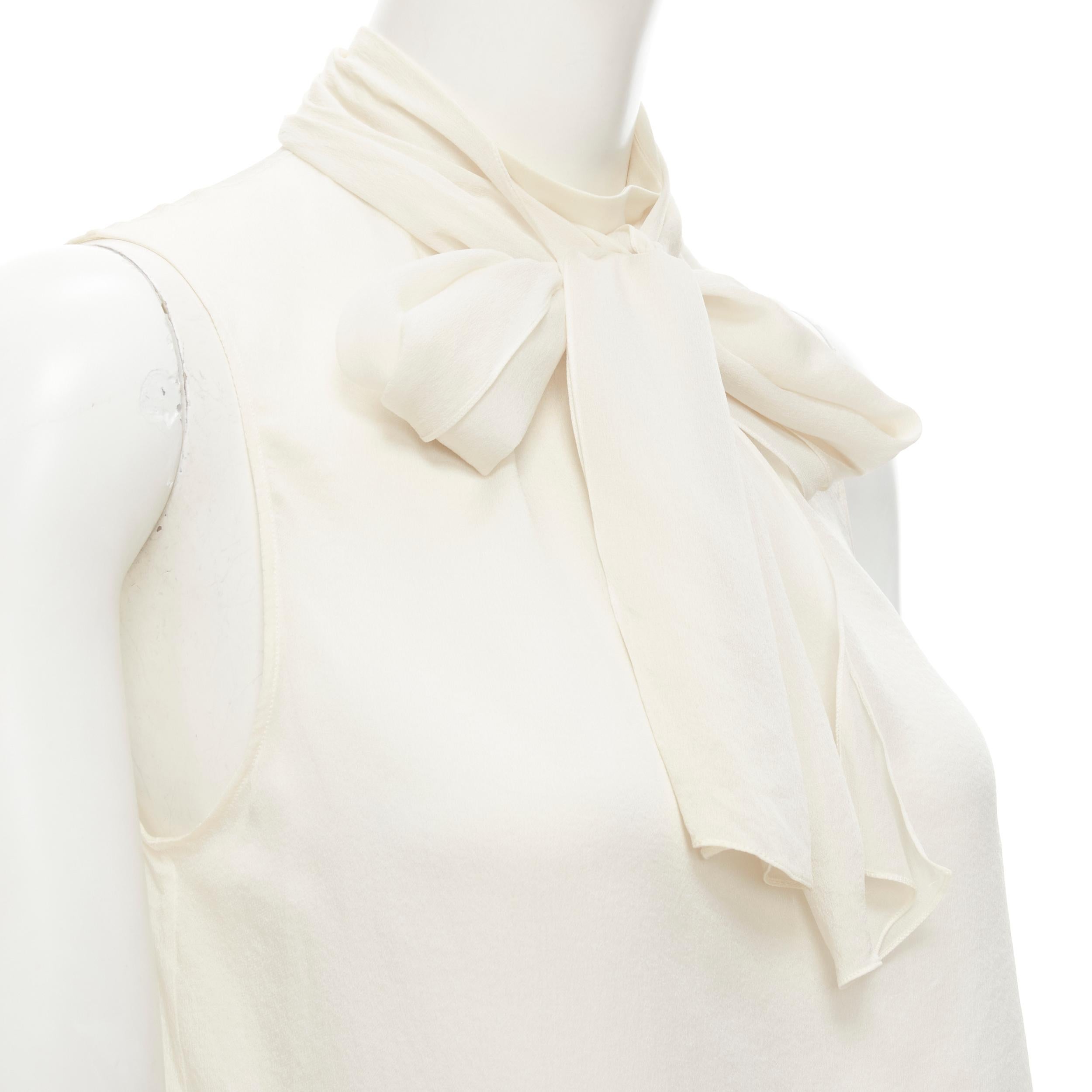 CHRISTIAN DIOR Vintage John Galliano 100% silk white pussy bow tank top FR36 S 
Reference: LNKO/A01947 
Brand: Christian Dior 
Designer: John Galliano 
Material: Silk 
Color: White 
Pattern: Solid 
Closure: Button 
Extra Detail: Button keyhole at