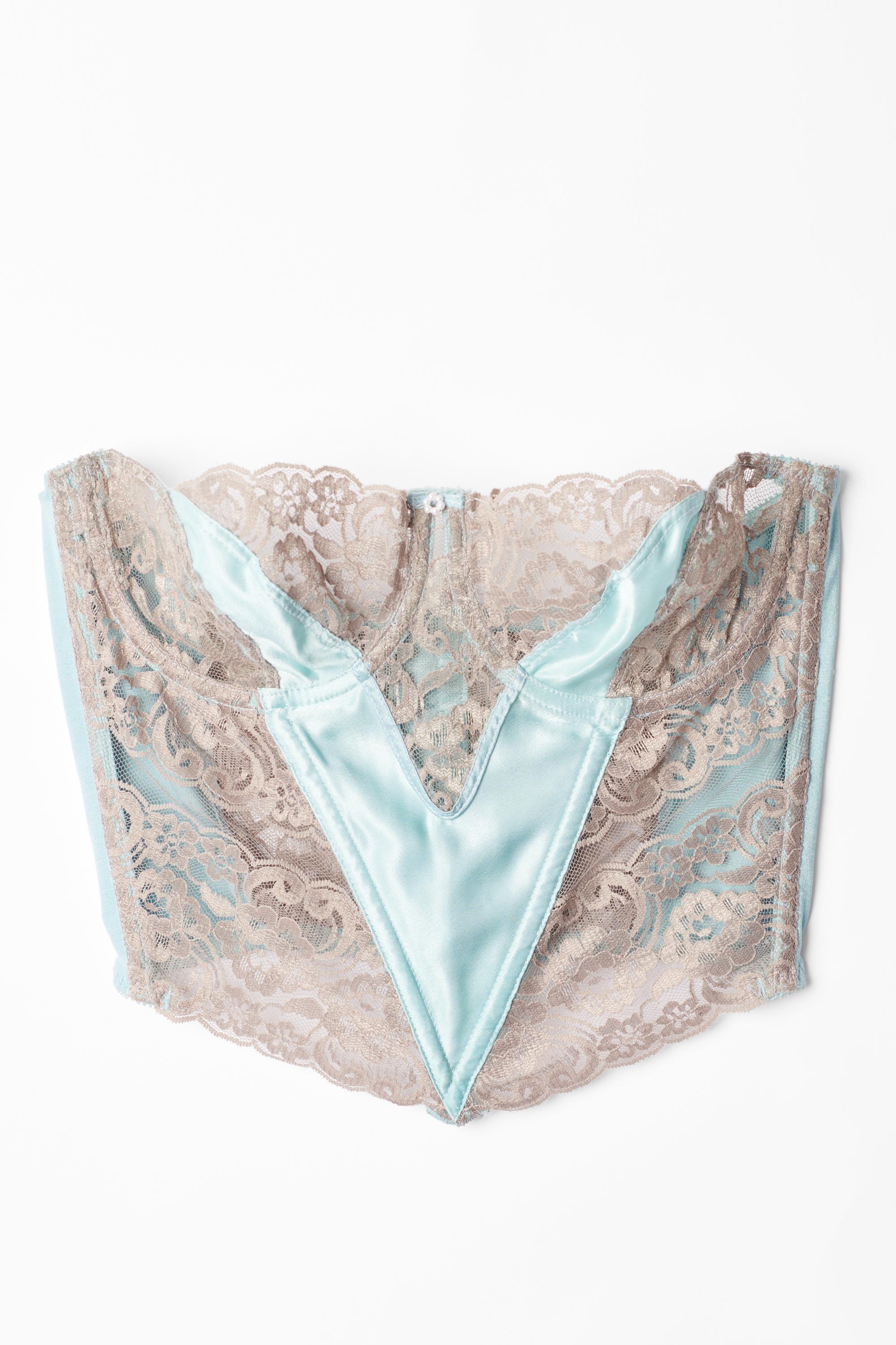 Vintage Christian Dior lace taupe and blue satin corset. Features satin and lace panelling allover, with blue satin and taupe lace, semi-sheer cups and pearl centre and corset back closure. In excellent vintage condition.
Authenticity