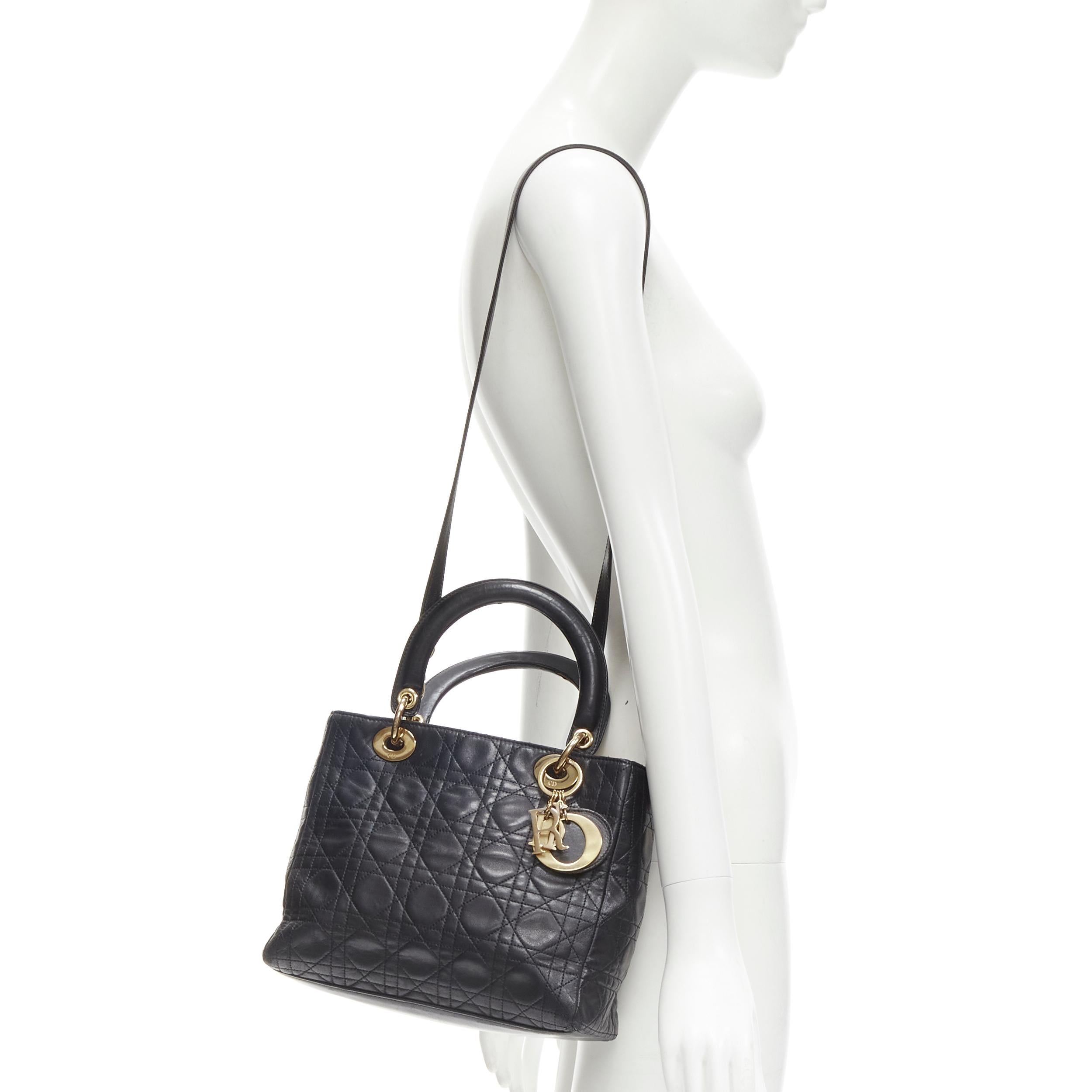CHRISTIAN DIOR Vintage Lady Dior black cannage gold charm crossbody satchel bag
Brand: Christian Dior
Model: Lady Dior
Material: Leather
Color: Black
Pattern: Solid
Closure: Zip
Extra Detail: Gold-tone hardware. DIOR Charm on handle. Detachable