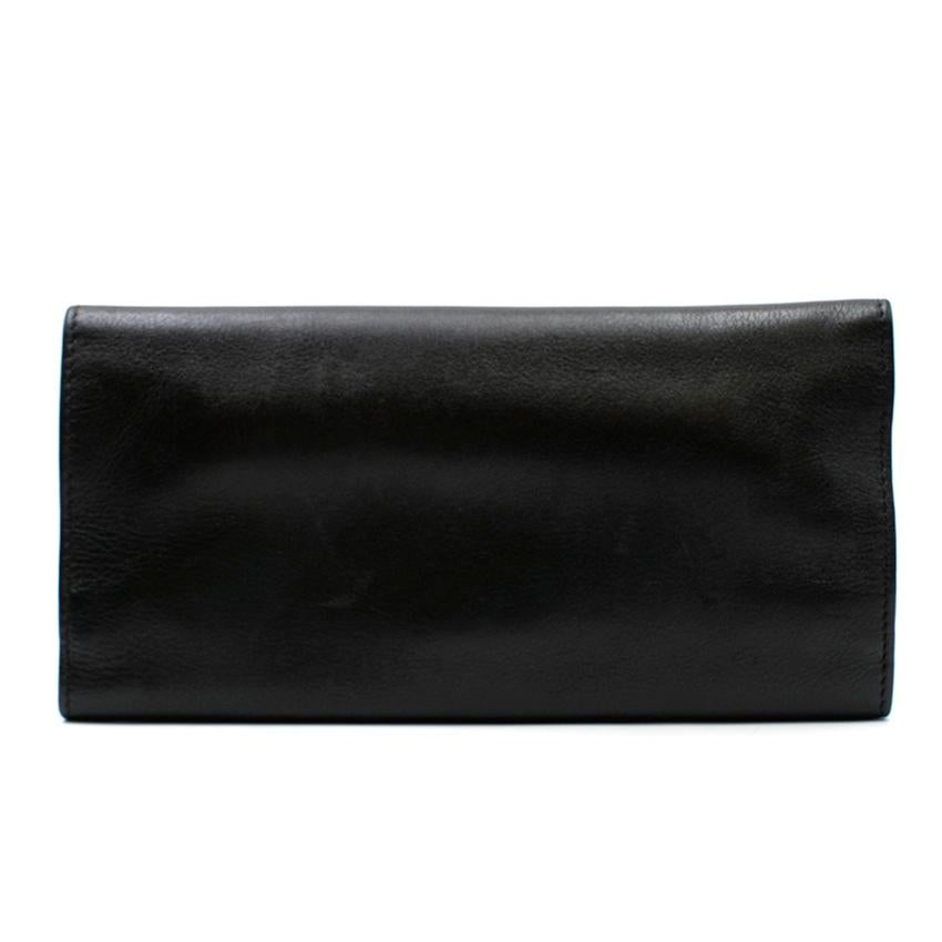 Christian Dior Leather Jewellery Wallet

- Rare find
- Soft black tri-fold leather jewellery wallet
- 'CD' embossed onto the front
- Magnetic popper closure
- Gold-tone hardware
- Red suede lining
- 2 flat zipped compartments and a central bracelet