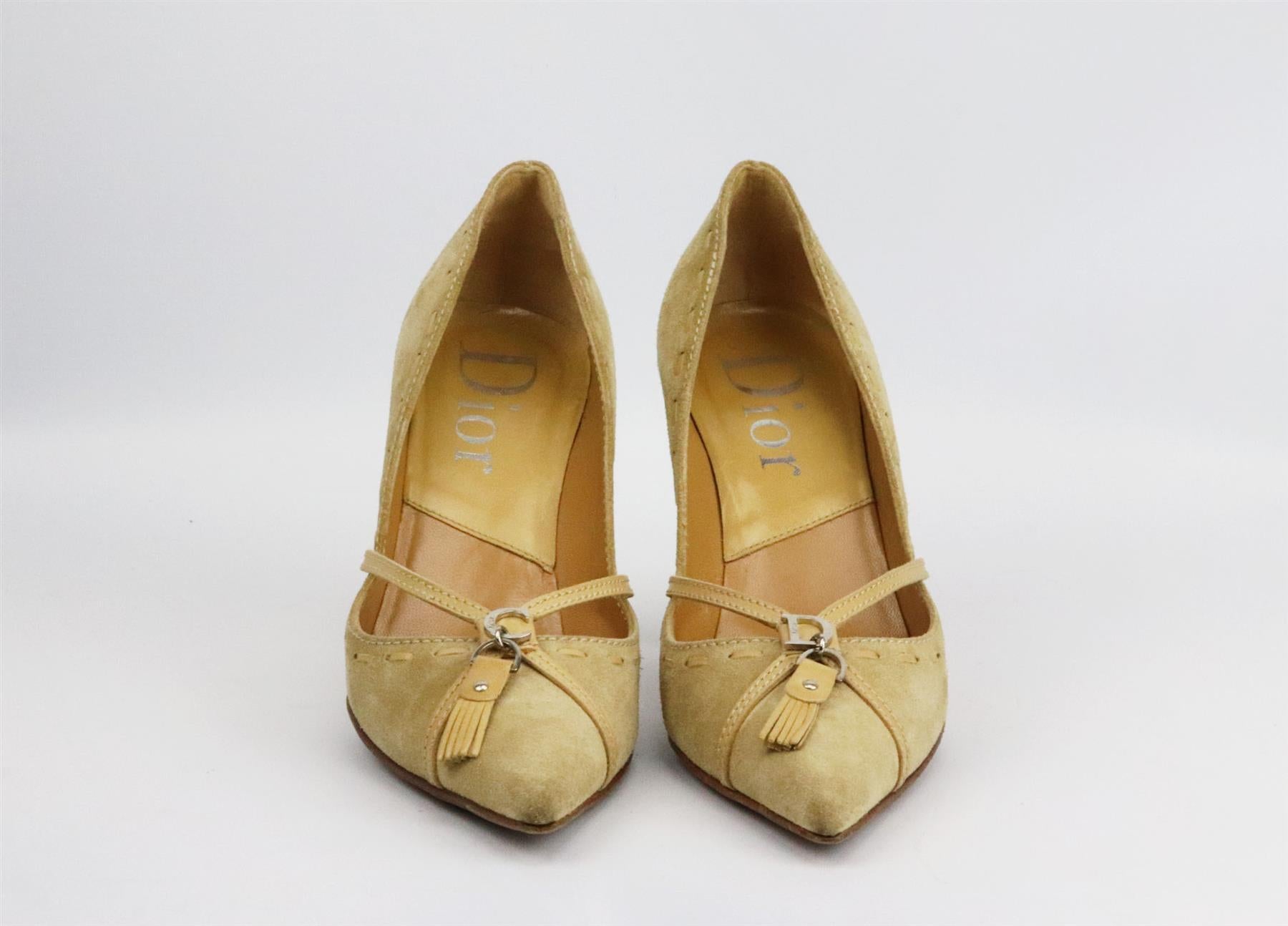 These vintage pumps by Christian Dior have been made in Italy from beige leather-trimmed suede, they're set on a structured stiletto heel that's balanced with a pointed toe and finished with the brand’s iconic CD with tassel detail. Heel measures